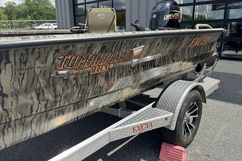 2026 Excel 183 Tomahawk boat with camouflage design on a trailer.