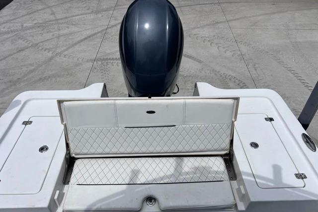 2021 Sportsman Tournament 234 SBX Bay Boat with open storage compartment and outboard motor.