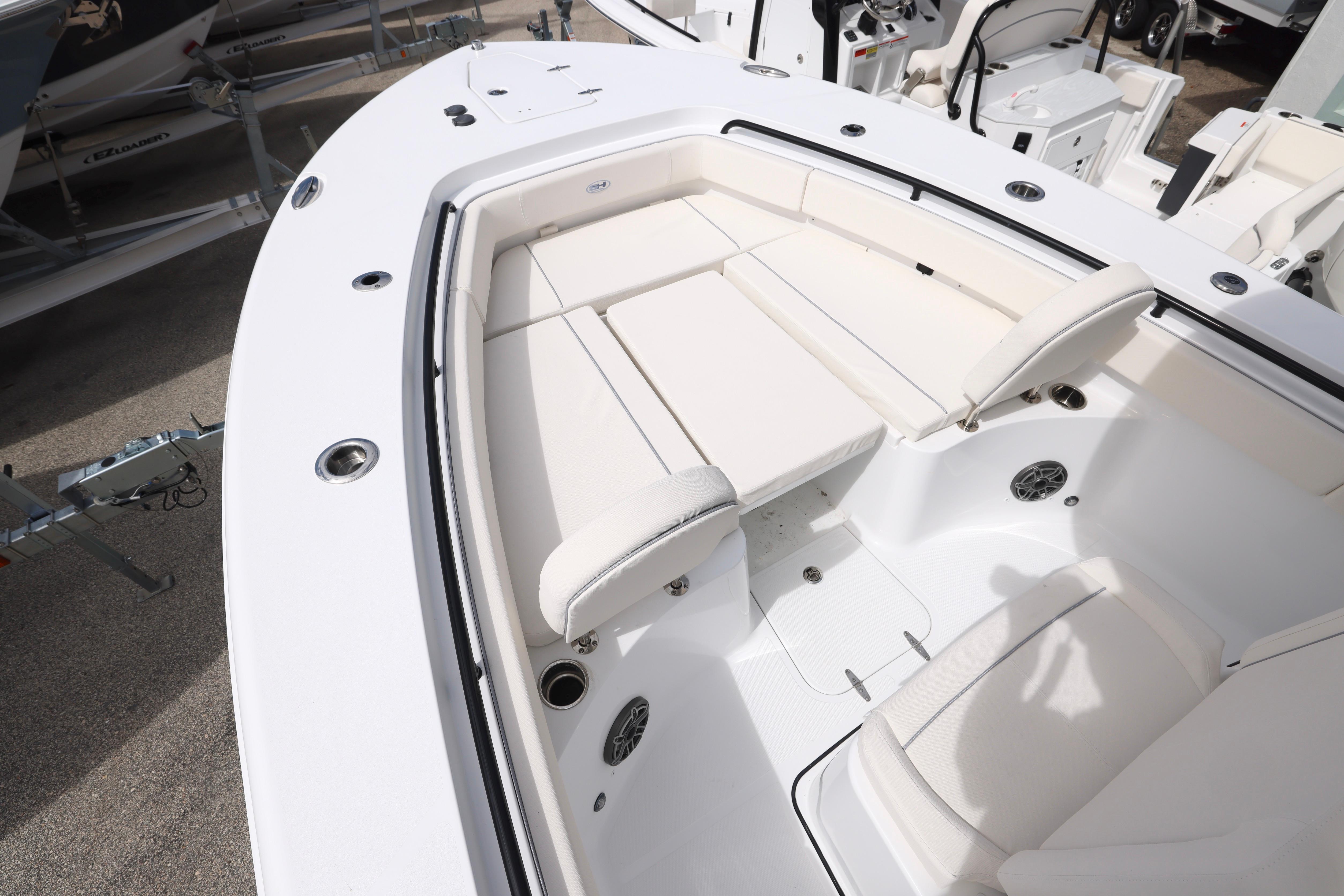 2026 Sea Hunt Gamefish 25 boat interior with white cushioned seating and sleek design.