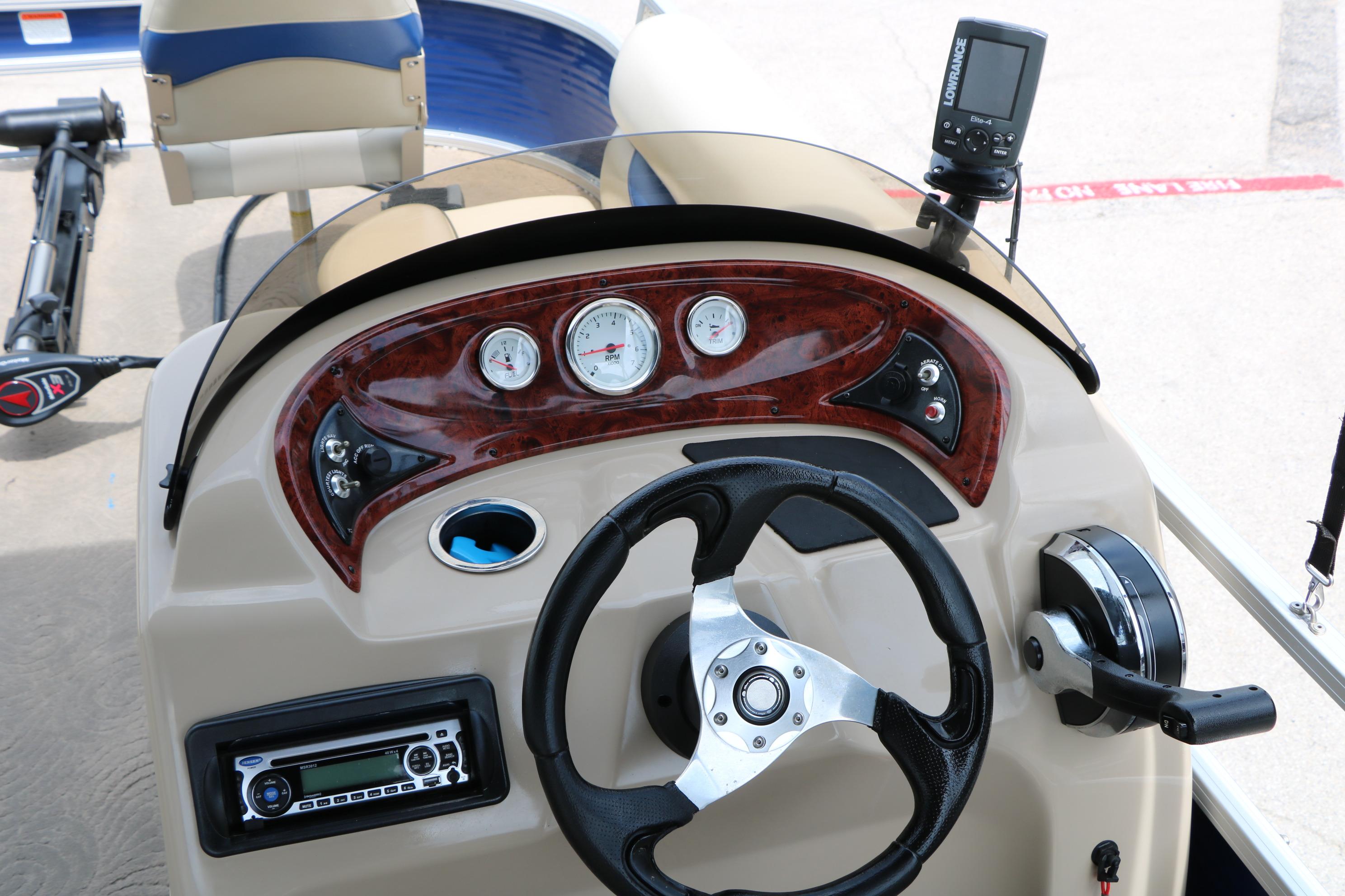2013 Sun Tracker Fishin' Barge 20 DLX dashboard with steering wheel and gauges.