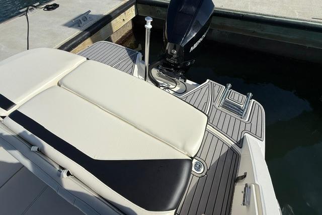 2022 Sea Ray SPX 210 Outboard boat with sleek seating and powerful engine at dock.