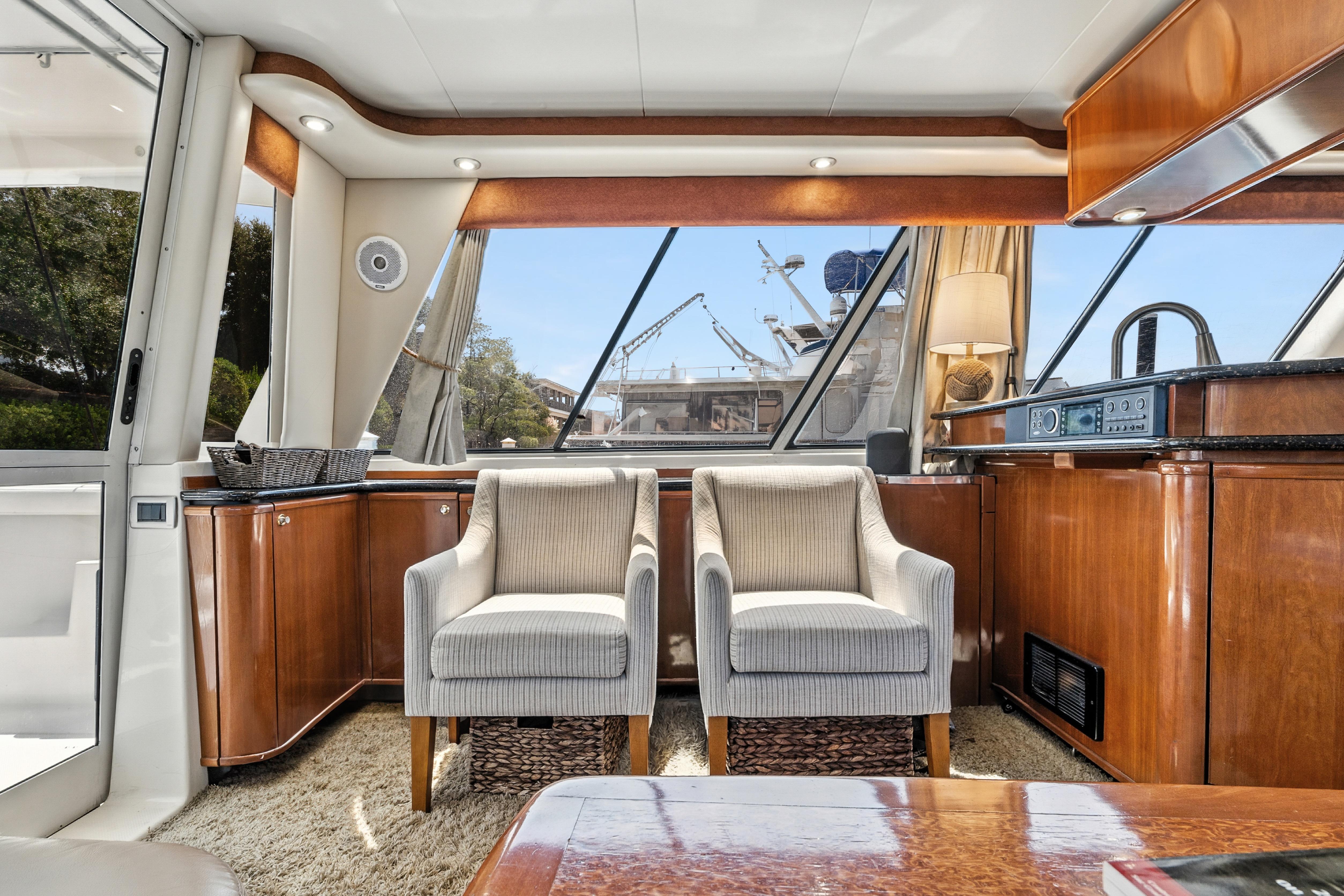 Luxurious interior of 2007 Meridian 490 Pilothouse yacht with elegant seating and wood finishes.