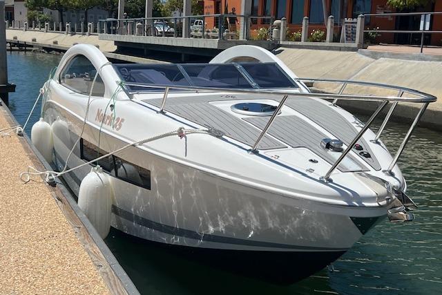 2024 Bracewell 25 boat docked in a marina, featuring sleek design and modern amenities.
