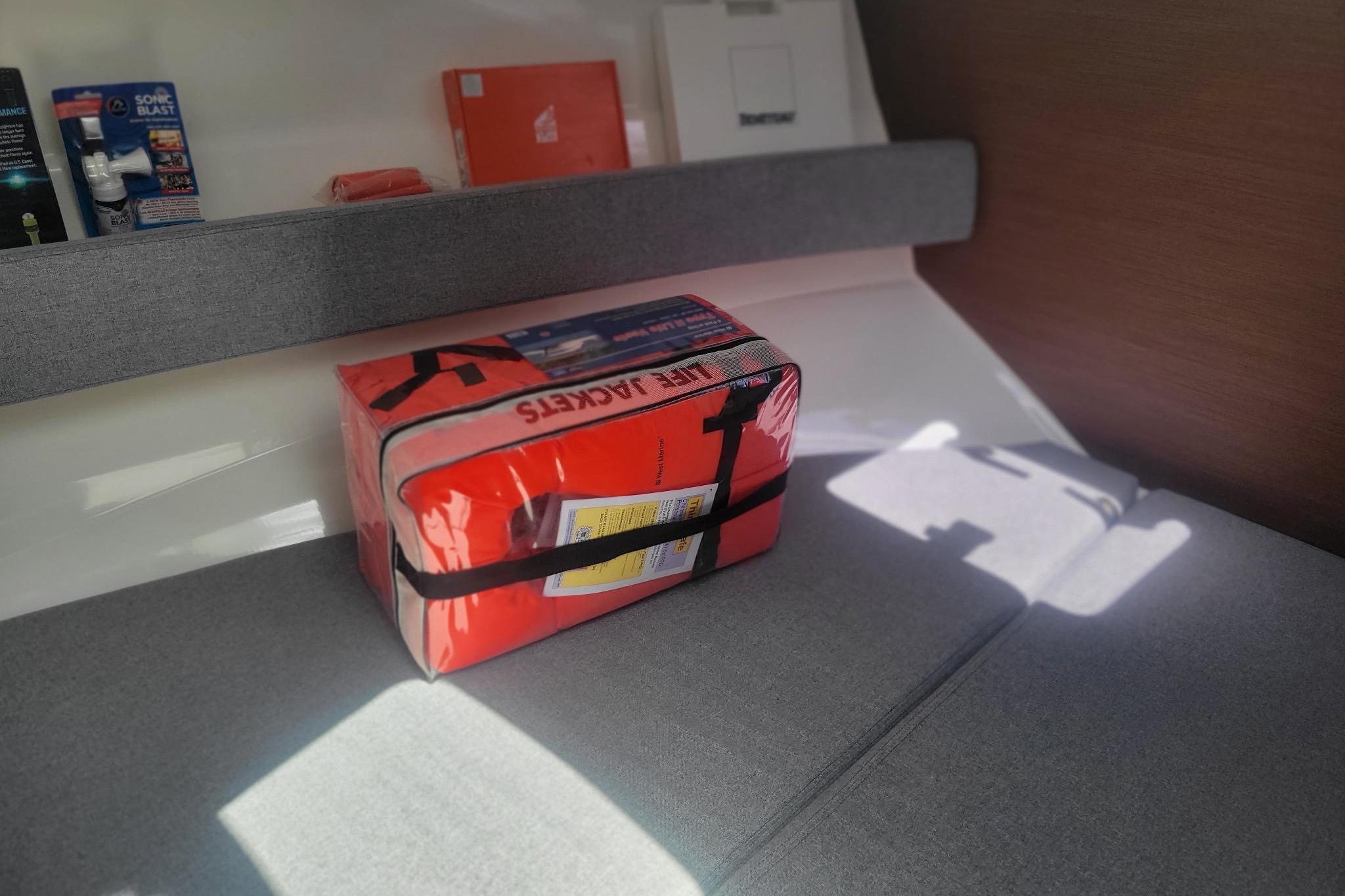 Interior of 2019 Beneteau Antares 23 with life jackets on a cushioned seat.