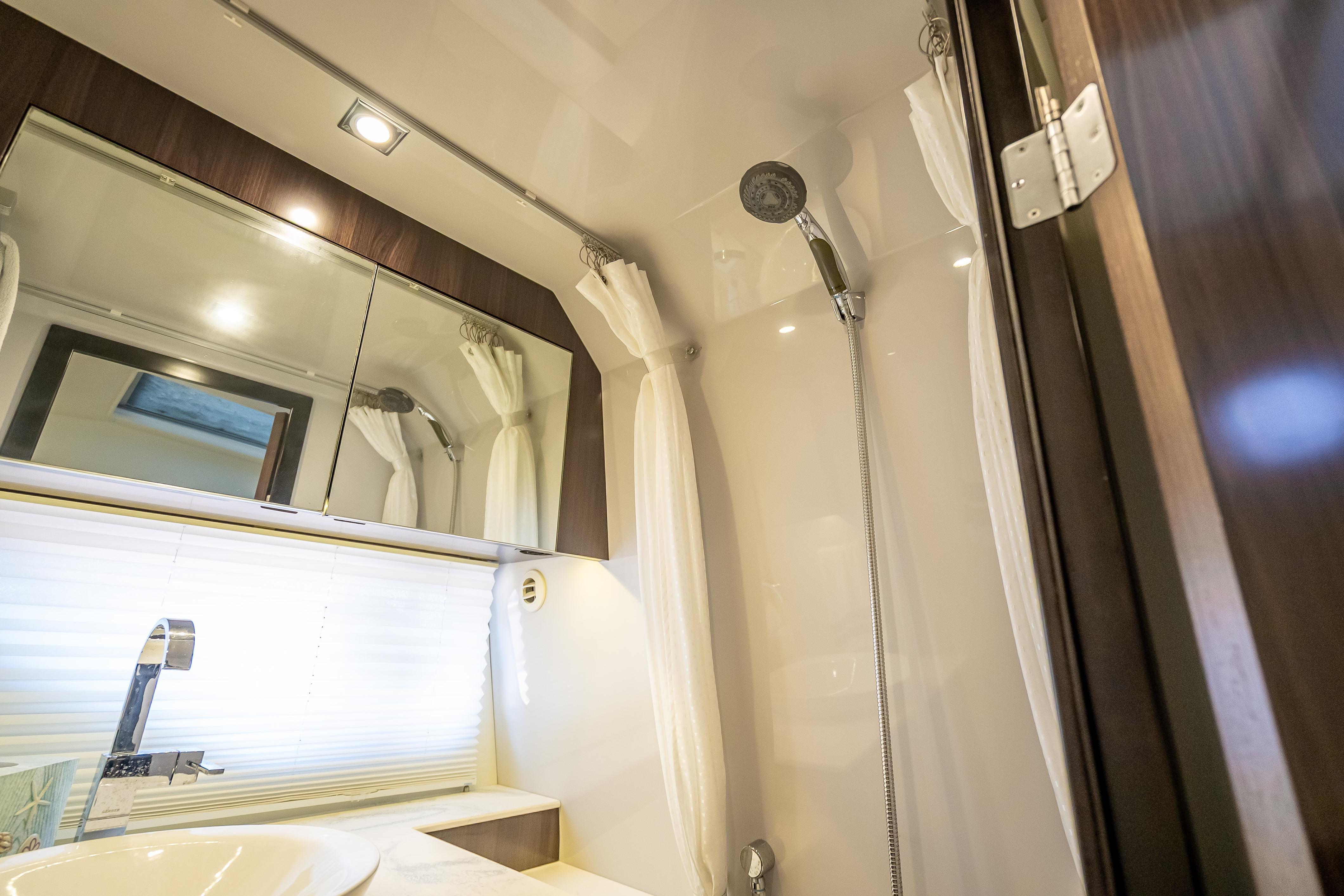 Luxurious bathroom interior of 2022 Cruisers Yachts 38 GLS OB with modern fixtures.