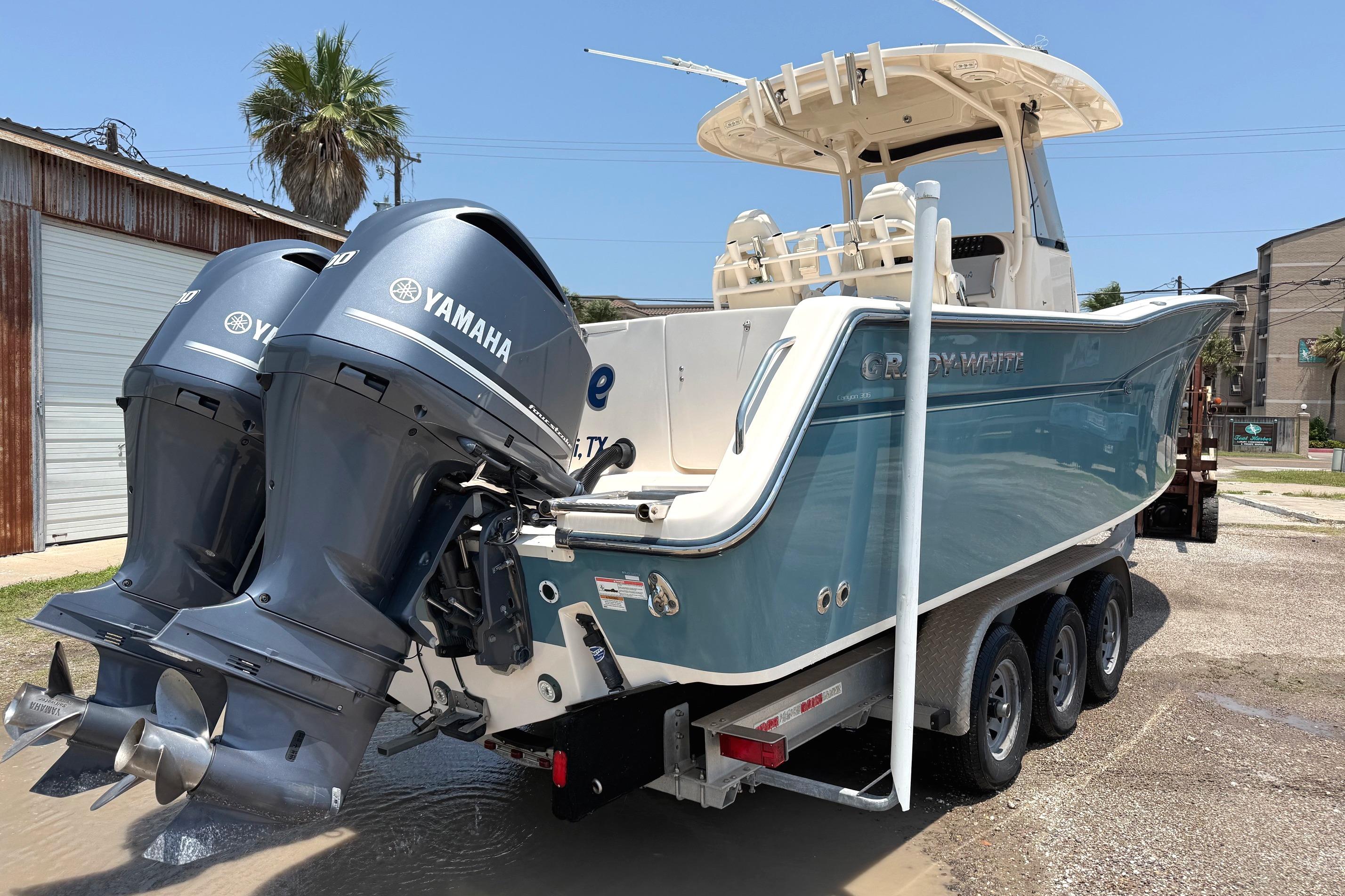 2018 Grady-White Canyon 306 boat with dual Yamaha engines on a trailer.