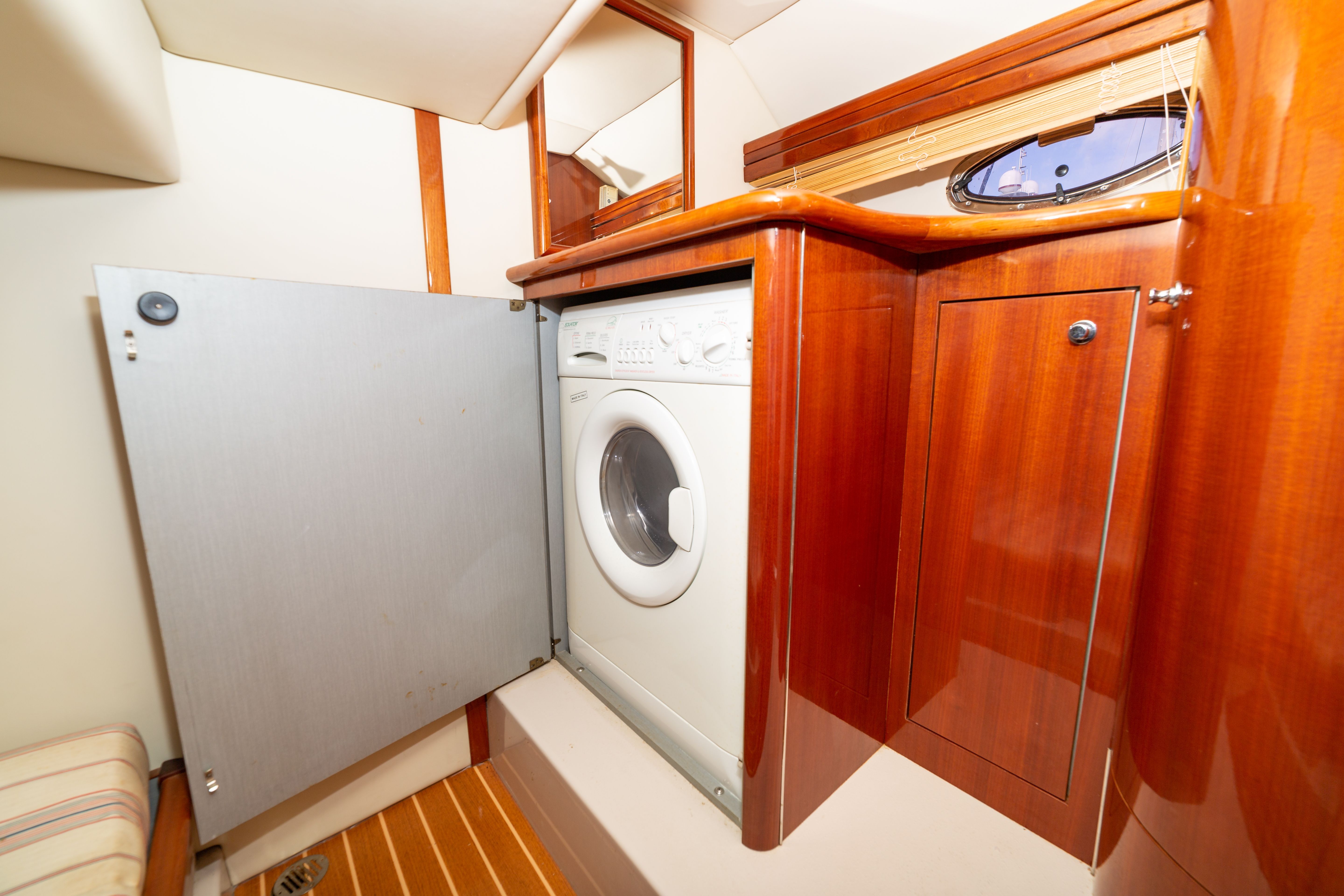 Interior of a 2004 Doral Alegria with a washing machine and wood paneling.
