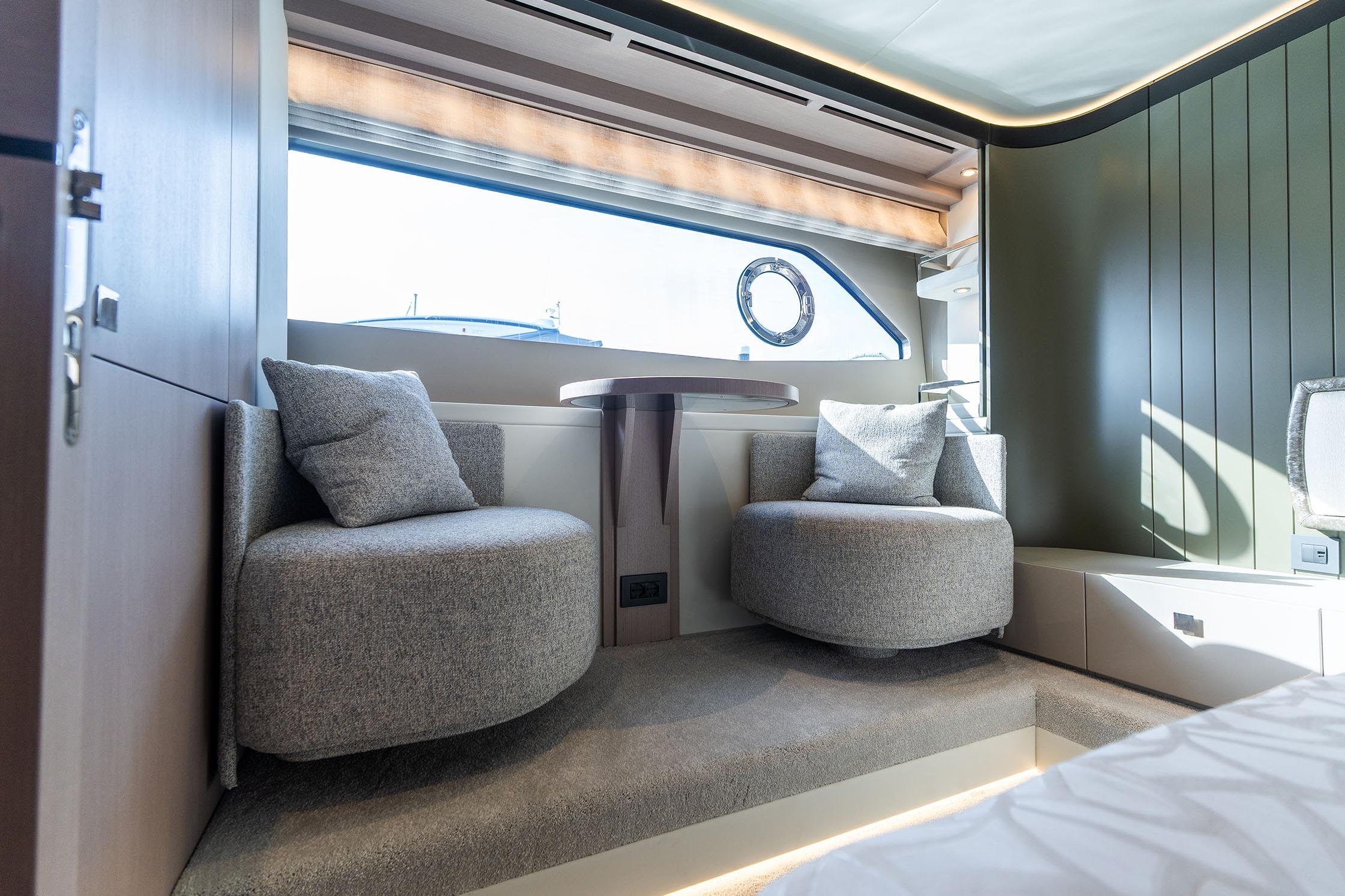 Luxurious interior of 2026 Sunseeker Manhattan 68 yacht with modern seating and window view.