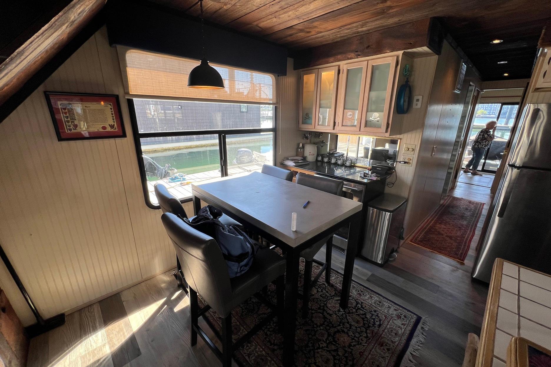 Interior of a 1993 Sumerset houseboat kitchen with dining area and window view.