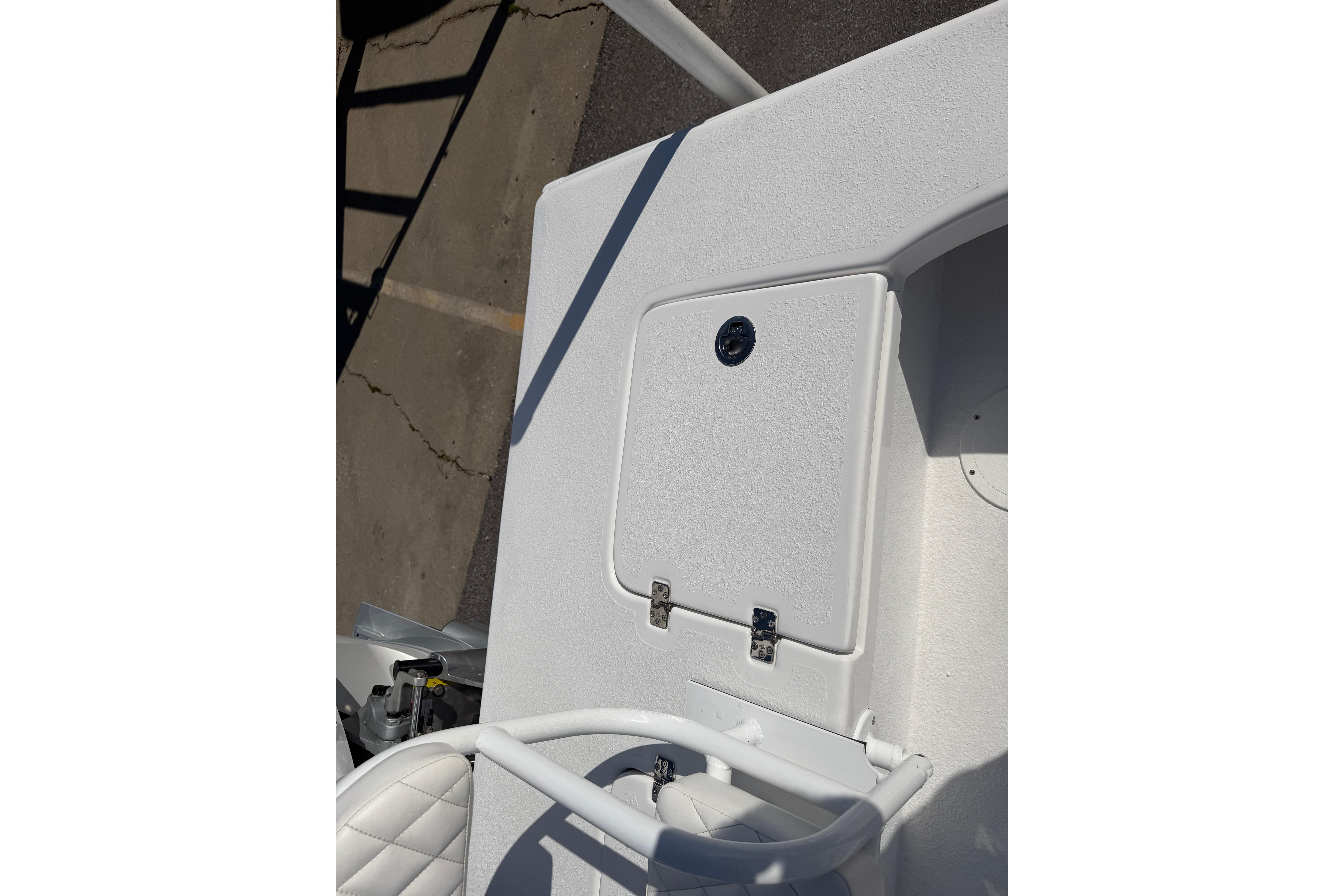 White deck of 2026 Skuta 24 Cat boat with storage compartment.