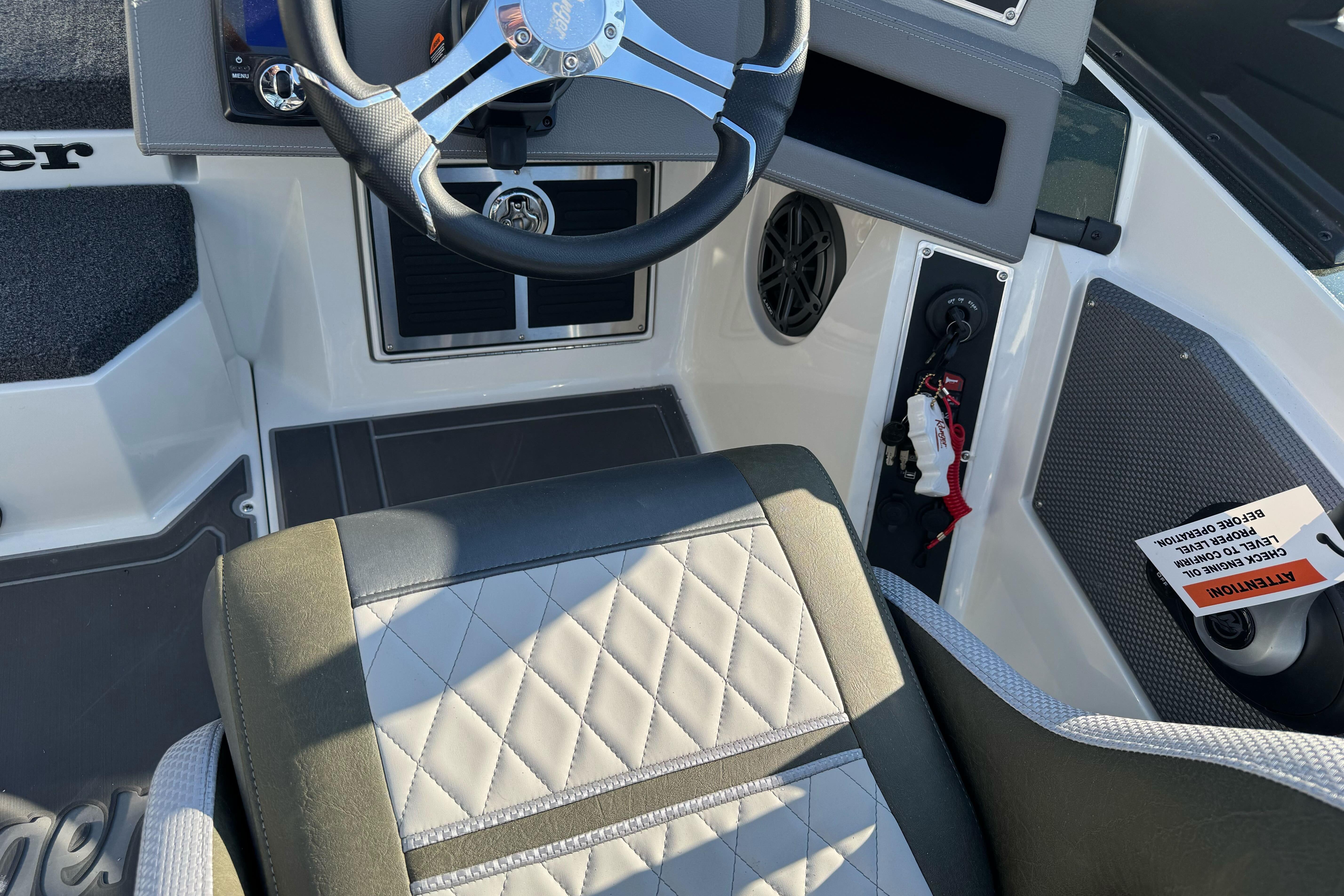 2026 Ranger 620xFS Pro boat interior with steering wheel and quilted seat design.