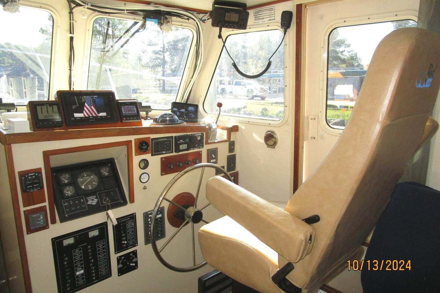 Interior of a 1997 Rosborough Trawler cockpit with navigation instruments and captain's chair.