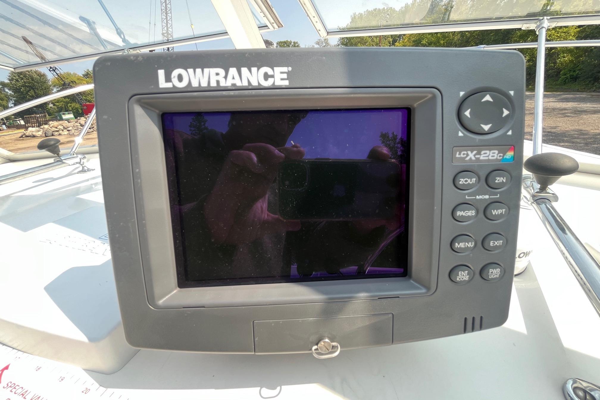 Lowrance LCX-28c GPS unit on a 1975 Bertram 26 Moppie boat dashboard.