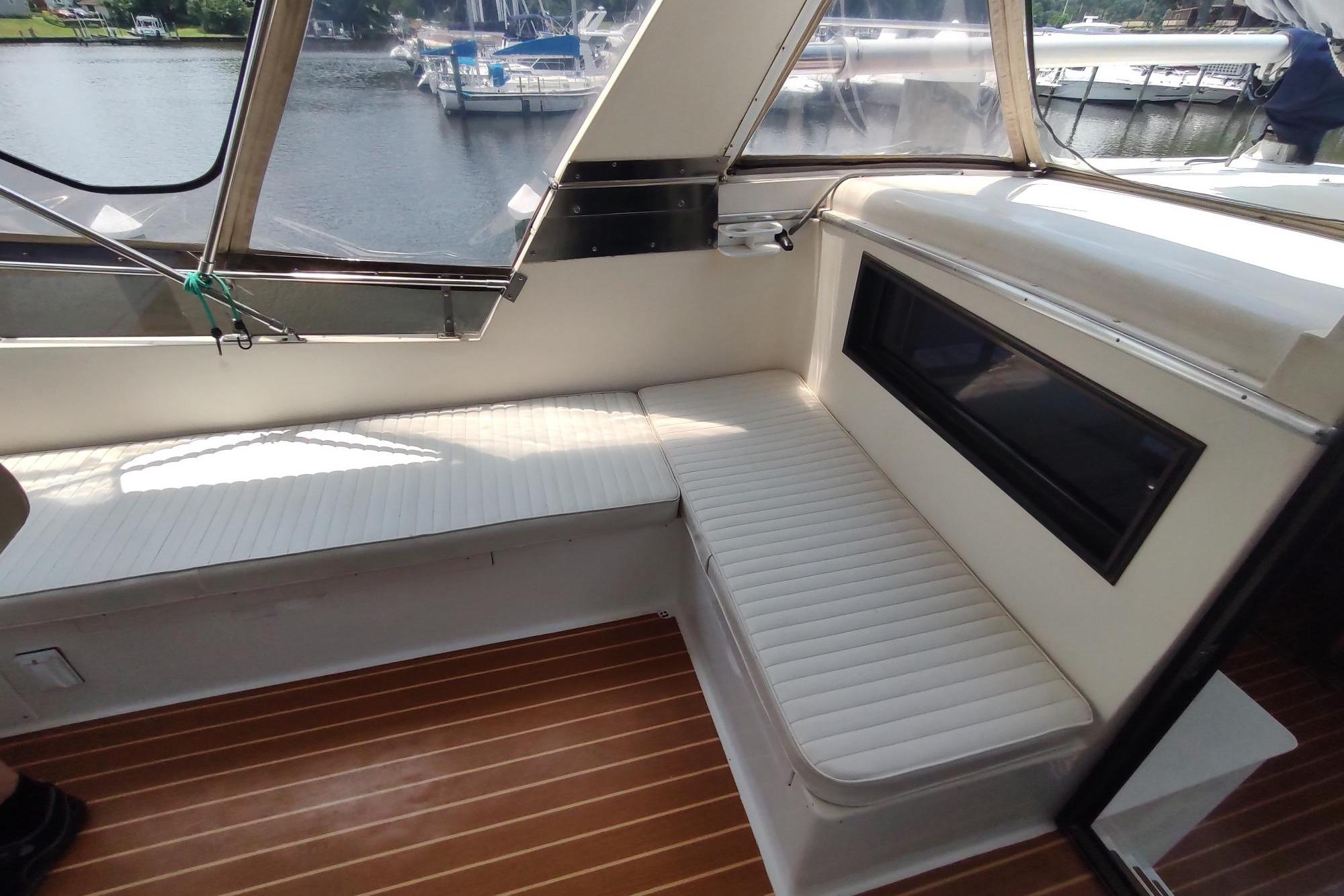 1989 Hyatt Double Cabin Motoryacht interior with white seating and wood flooring.