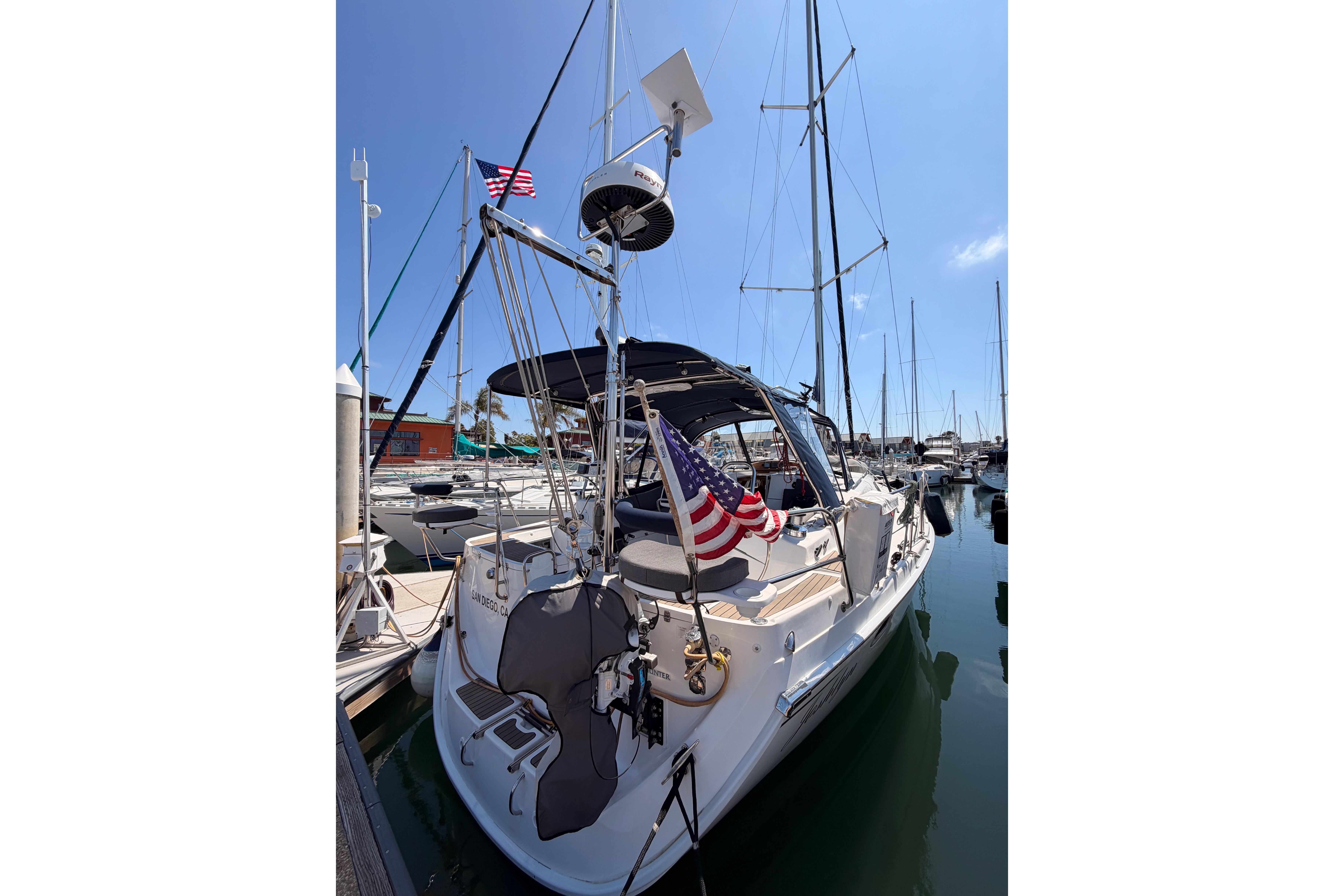 2008 Hunter 45 Deck Salon sailboat docked in marina with American flag.