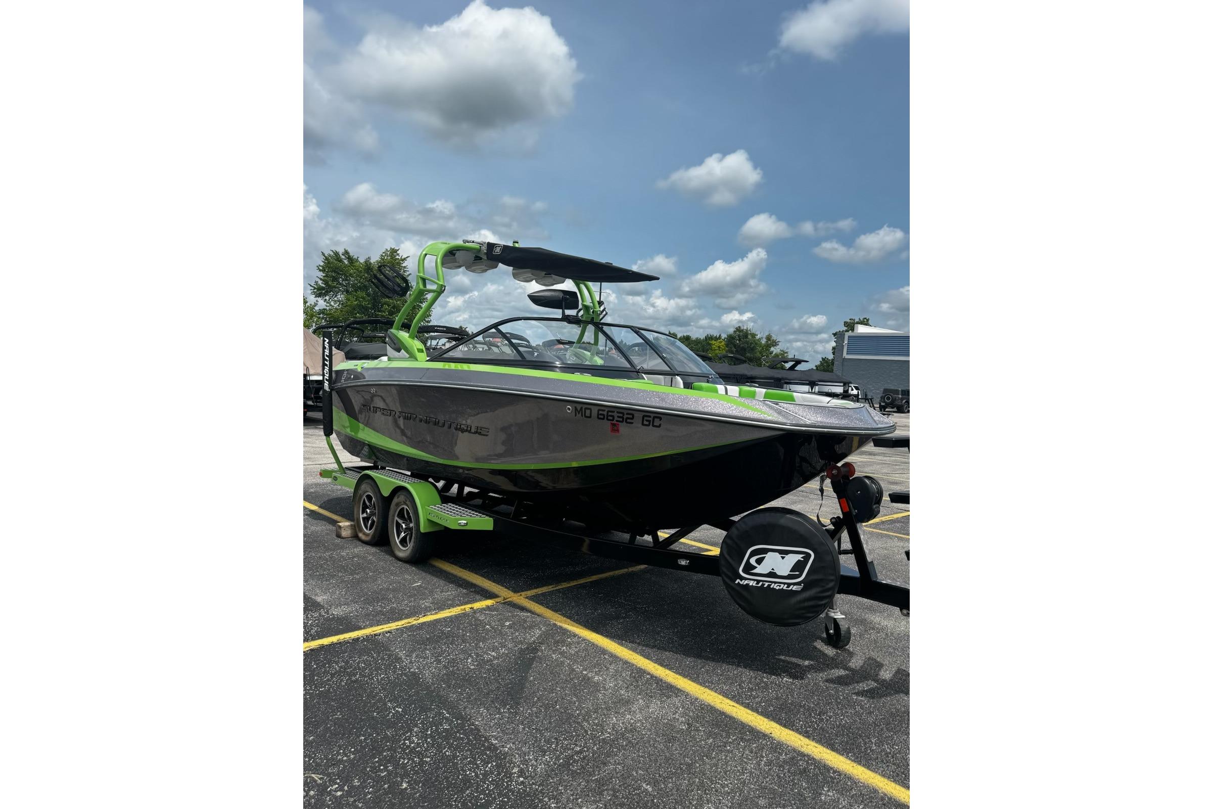 2014 Nautique Super Air Nautique G21 boat on trailer, green and gray design.