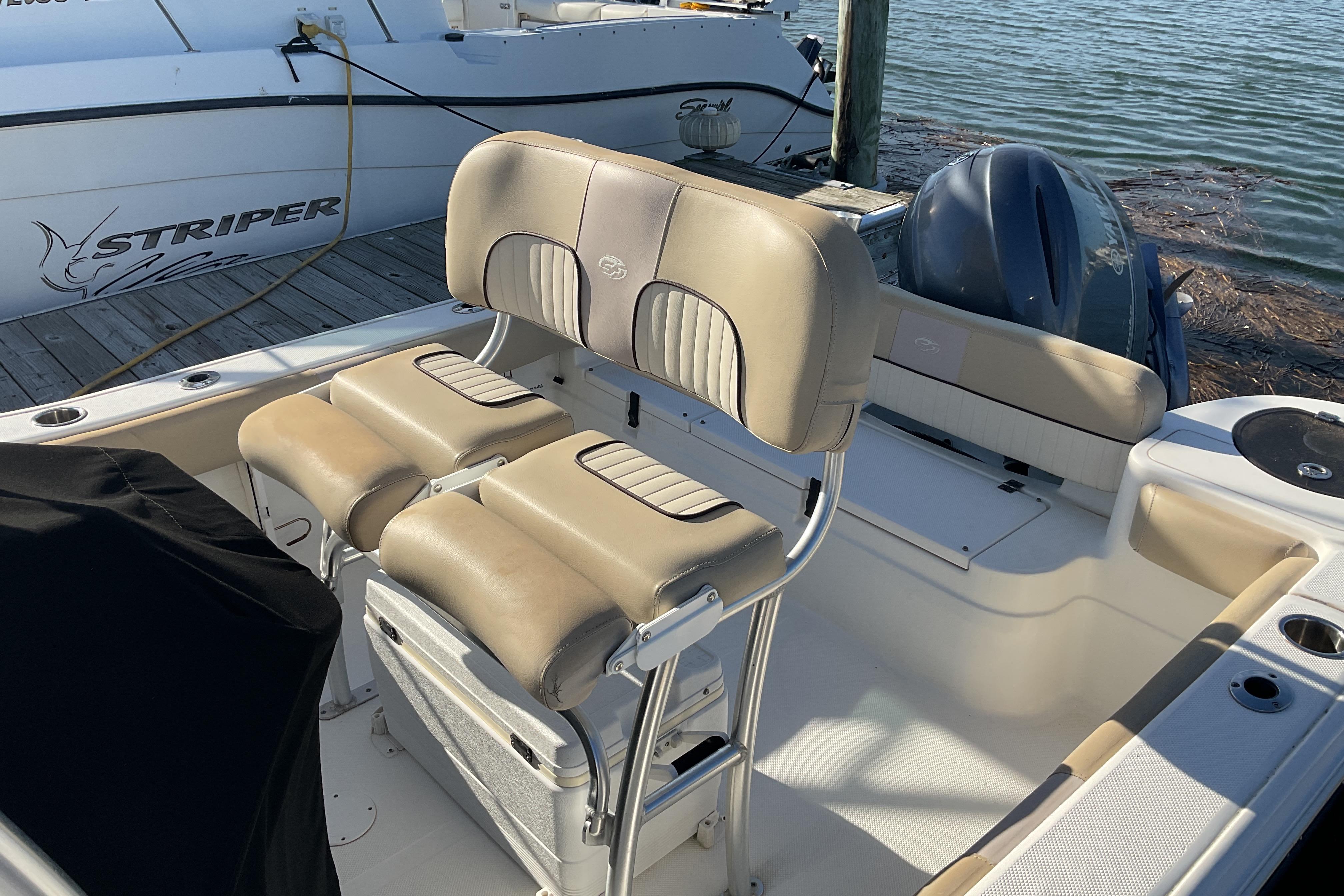 2016 Sea Fox 226 Commander boat interior with beige seating and outboard motor.