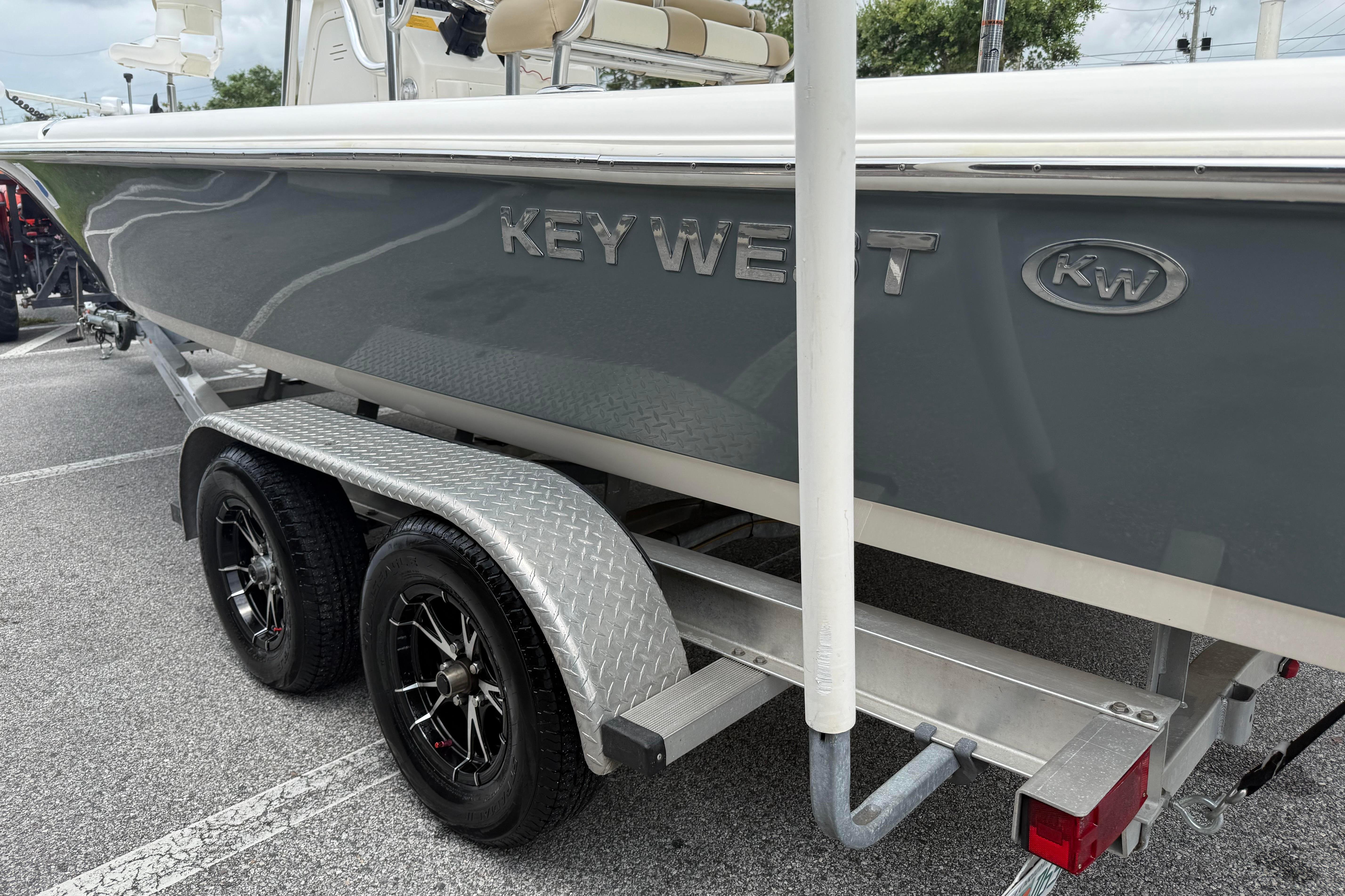 2017 Key West 246 Bay Reef boat on a dual-axle trailer in a parking lot.