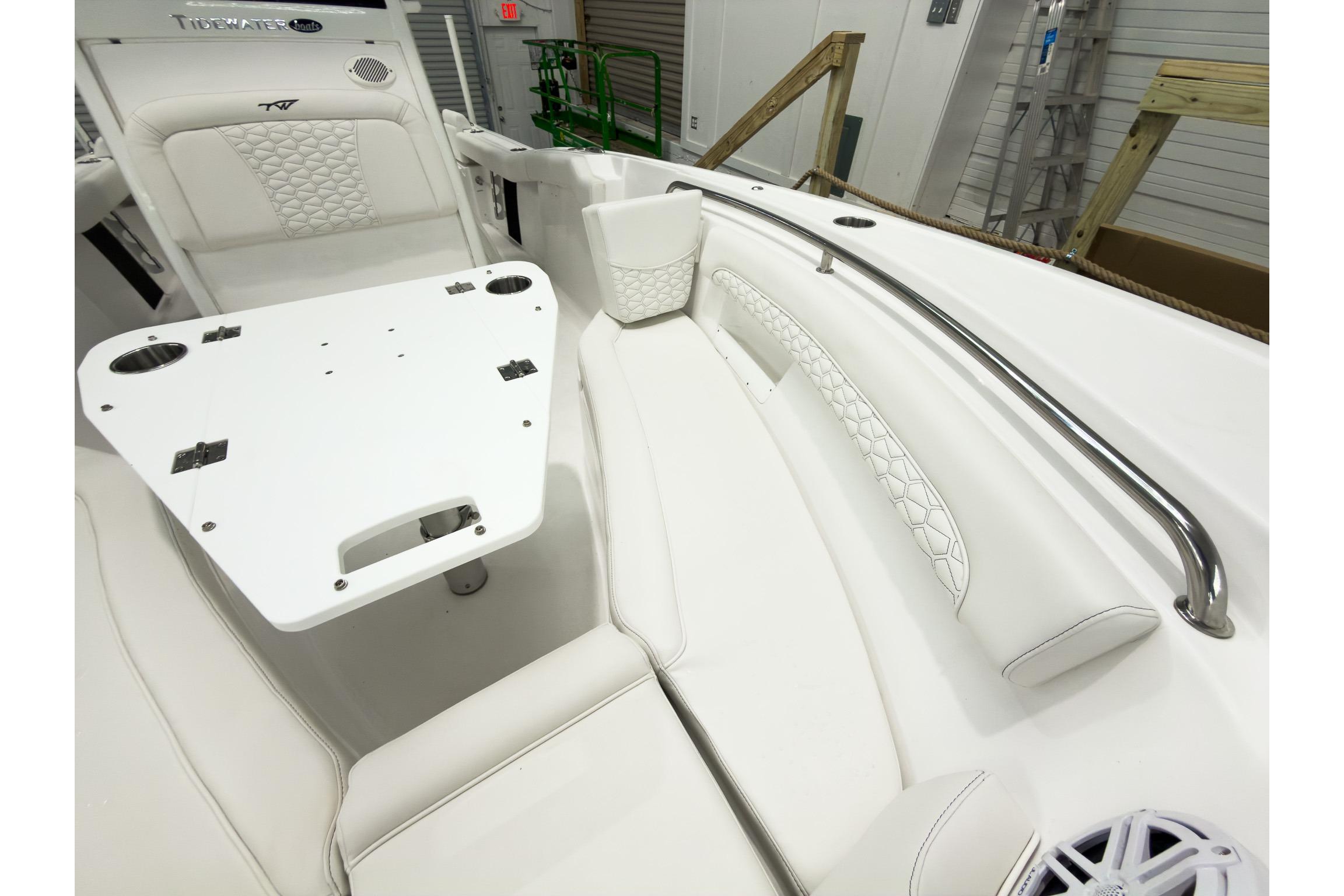 2026 Tidewater 232 LXF boat interior with white seating and table.