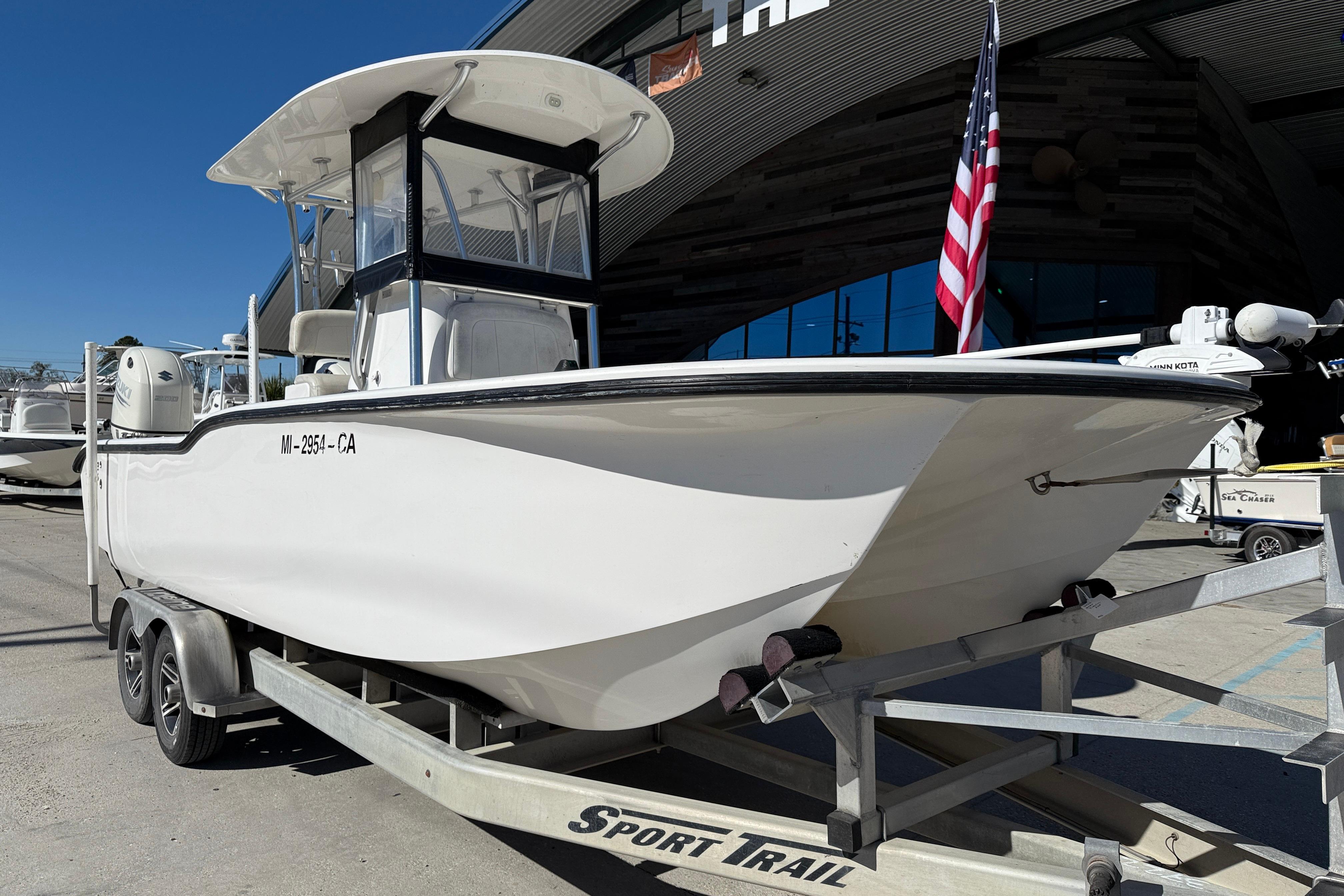 2020 Tideline 235 Hybrid boat on trailer, displayed outdoors with American flag.