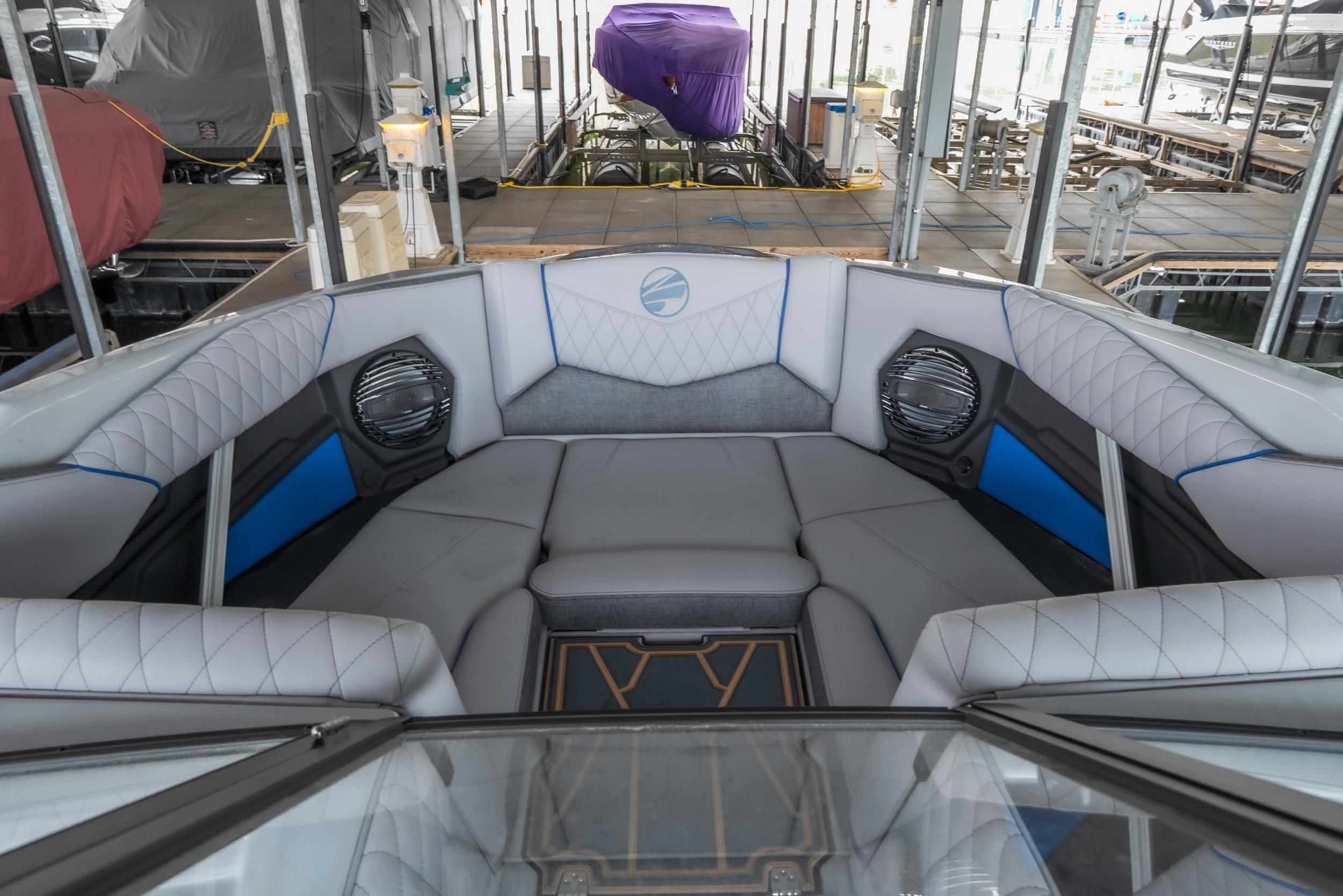 2026 Tigé Z3 boat interior with luxurious seating and modern design in a docked setting.