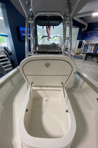2024 Key West 250 Bay Reef boat with open storage compartment in showroom.