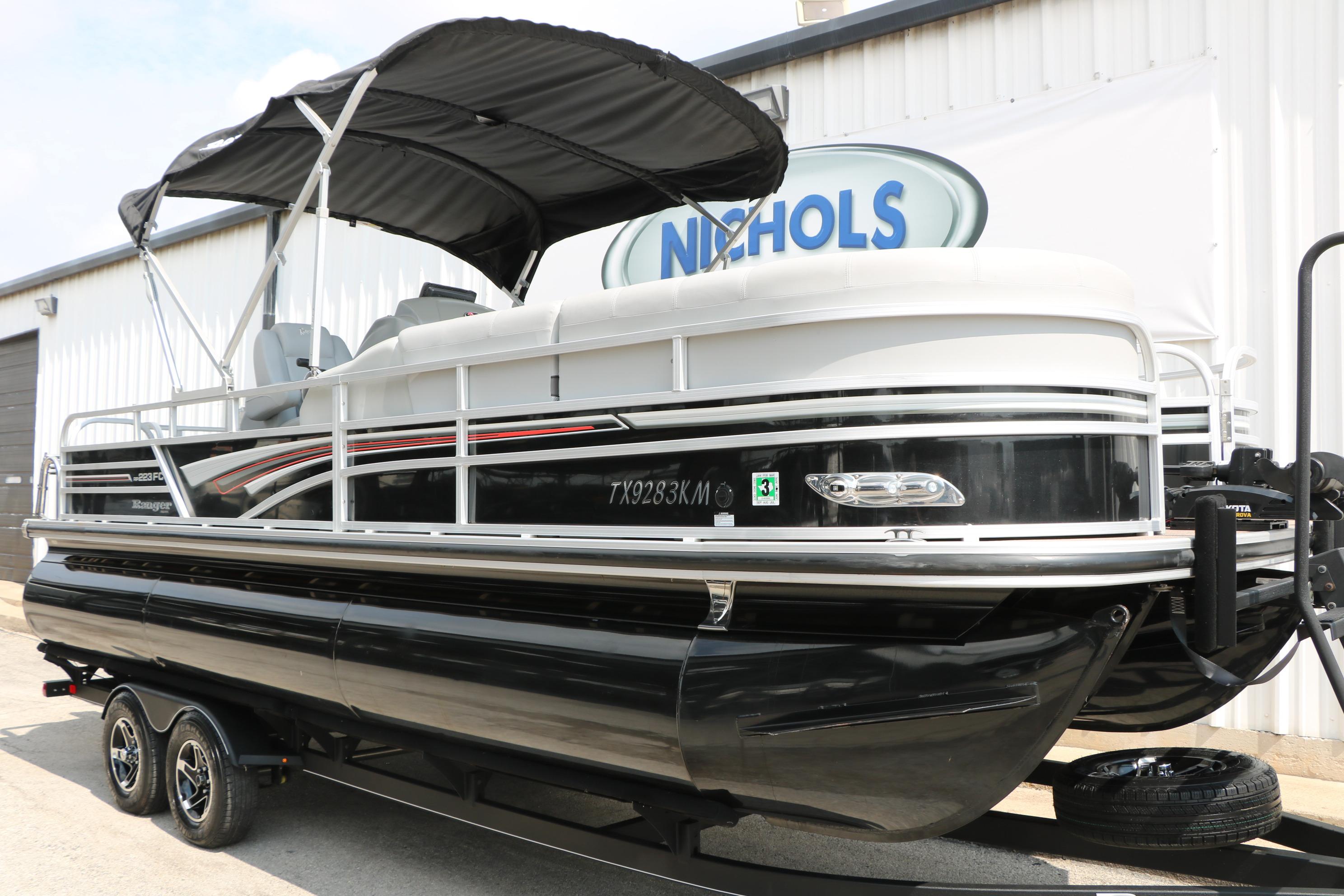 2021 Ranger 223FC pontoon boat with canopy on trailer, parked outside Nichols building.