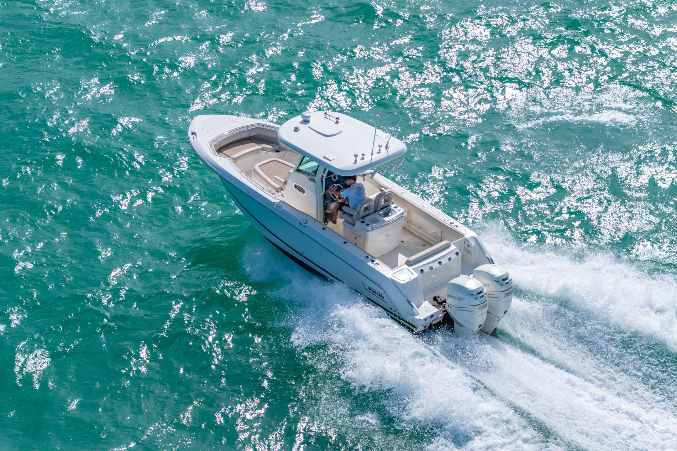 2016 Boston Whaler 280 Outrage cruising on vibrant turquoise waters.