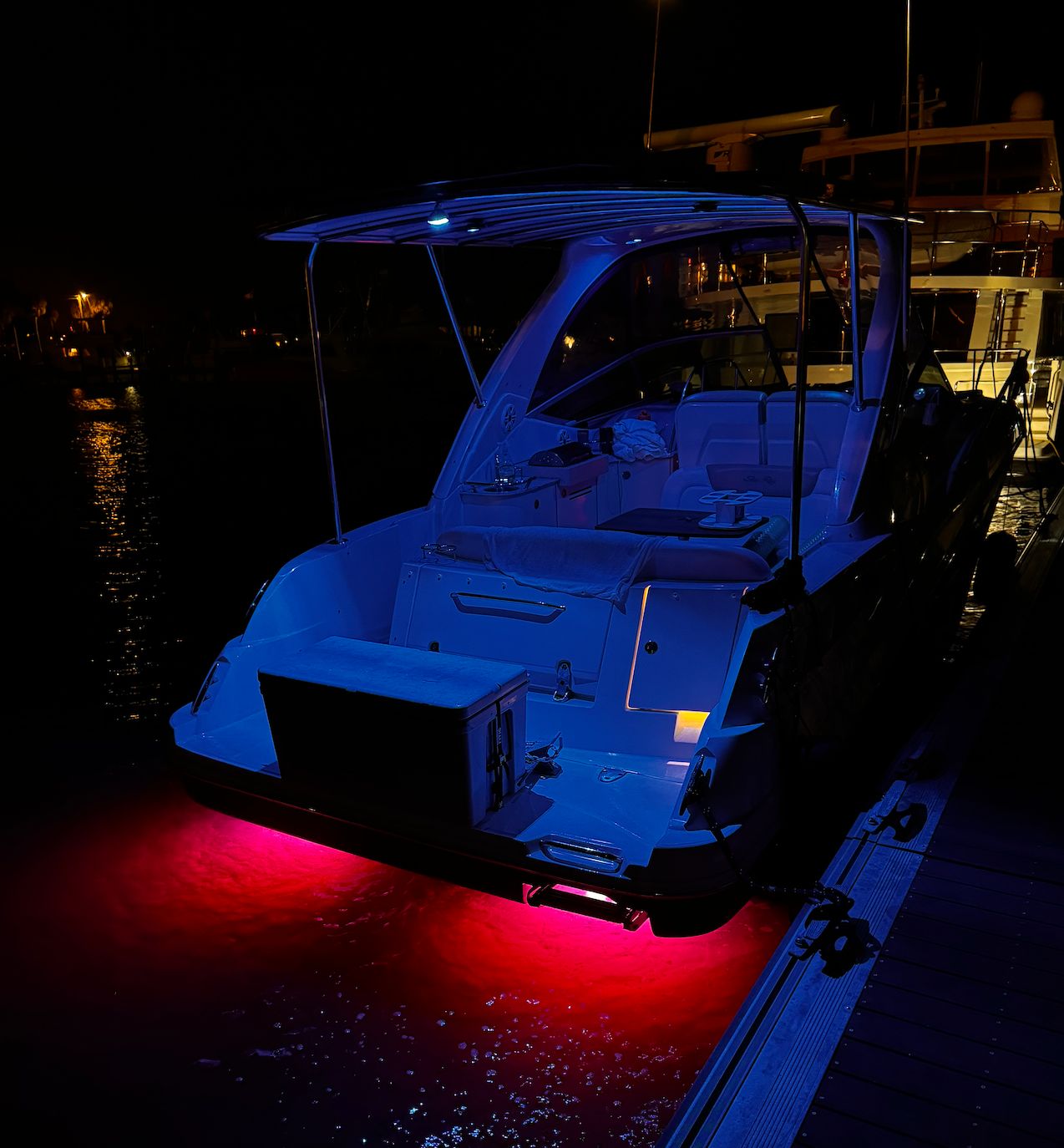 2008 Sea Ray Sundancer 310 with blue and red lighting at dock.