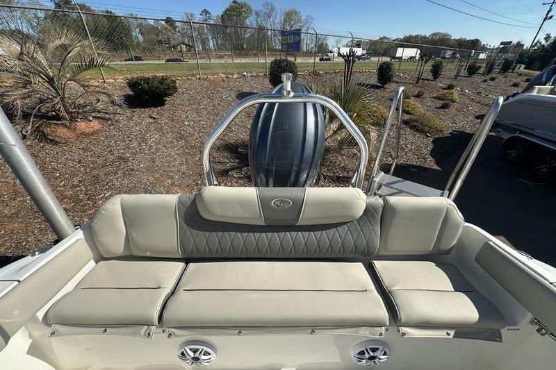 2026 Key West 219 FS boat interior with cushioned seating and stainless steel railing.