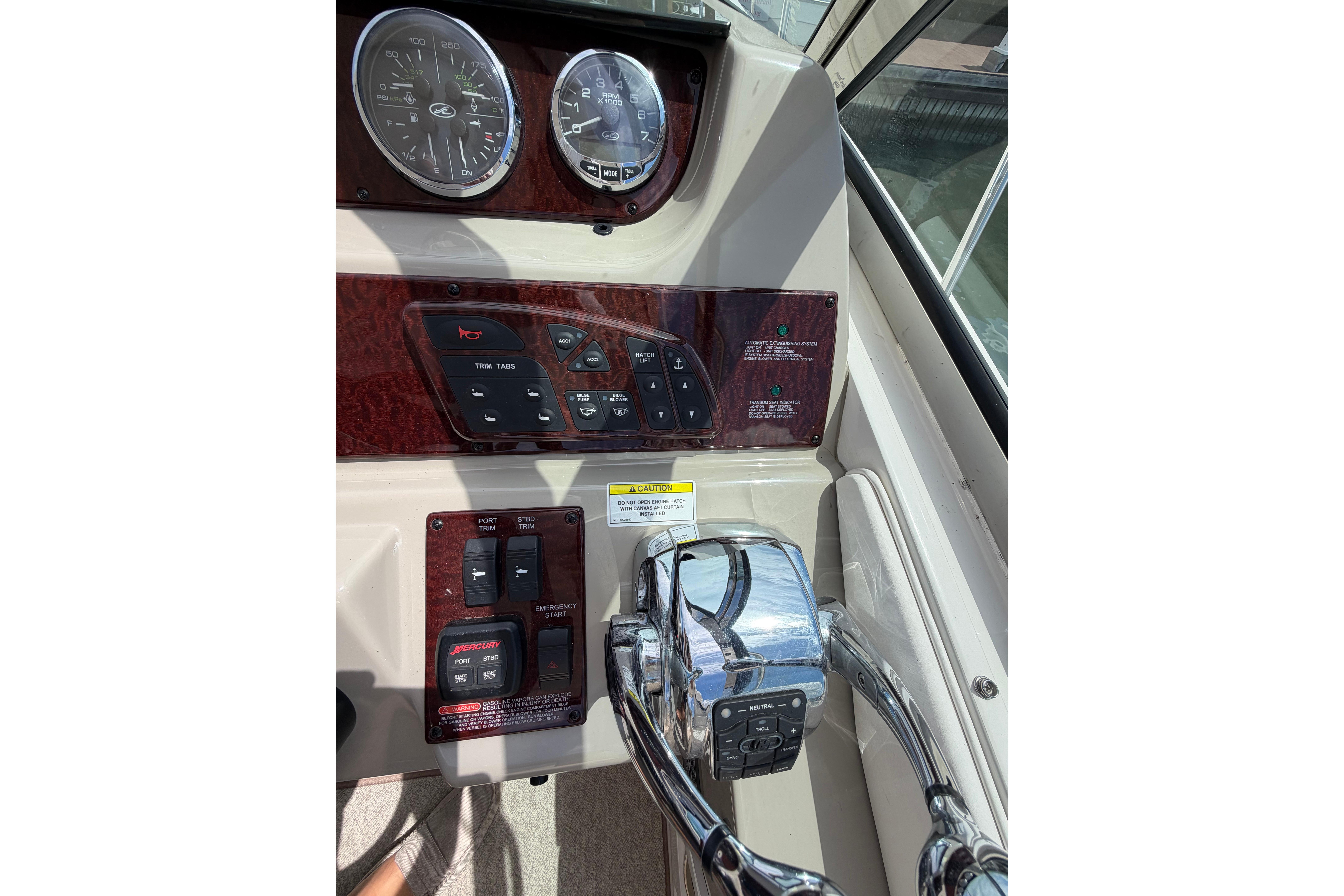 Control panel of a 2012 Sea Ray Sundancer 370 boat with gauges and switches.