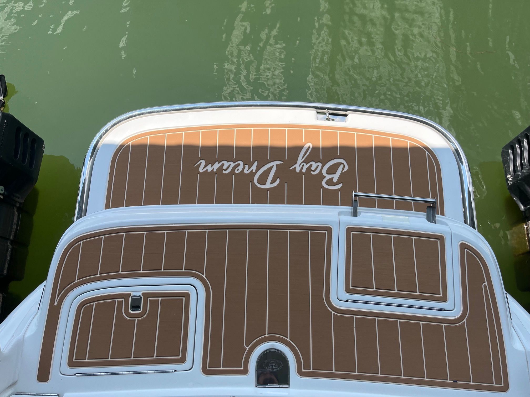 2001 Cobalt 262 with brown deck on green water.