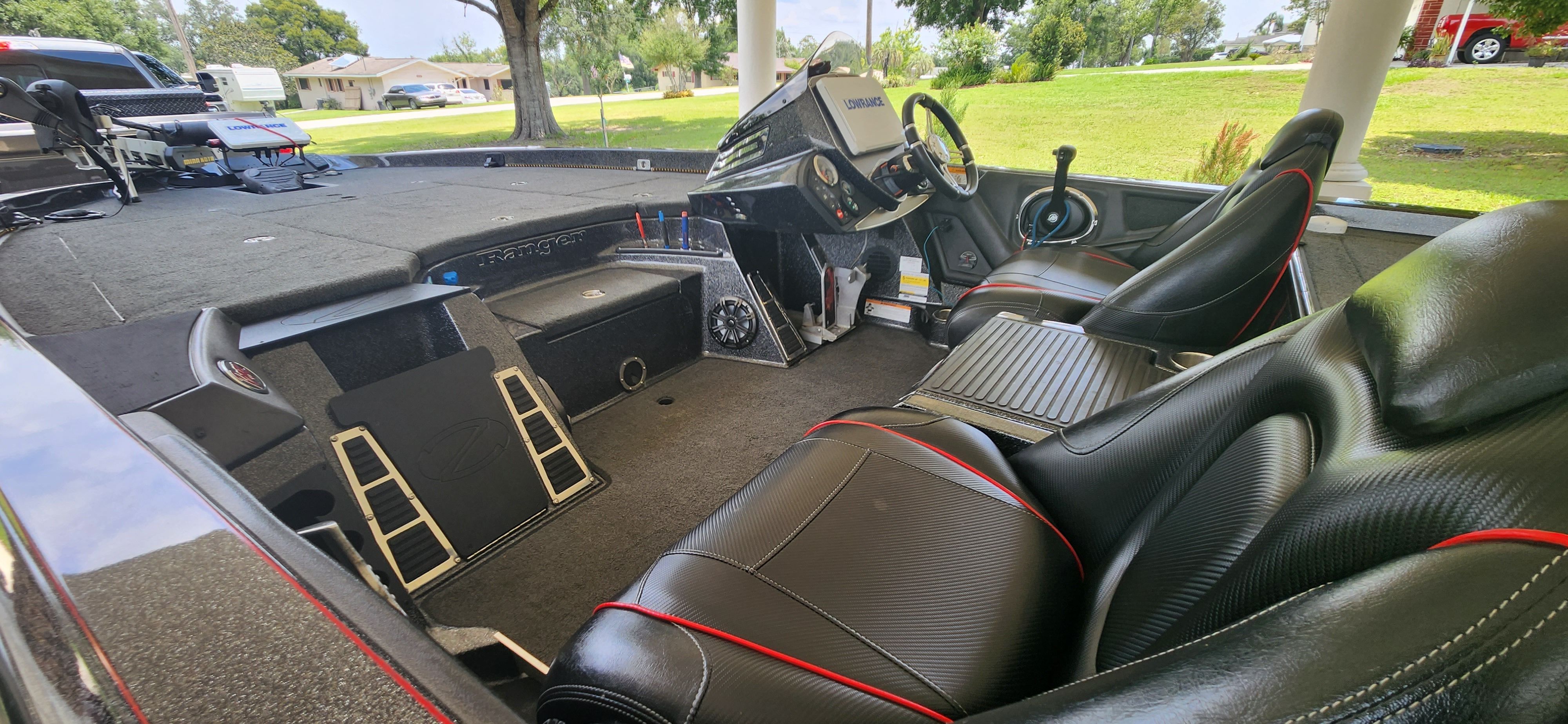 The image shows the cockpit of a 2017 Ranger Z520 Comanche boat with black seats and a helm.