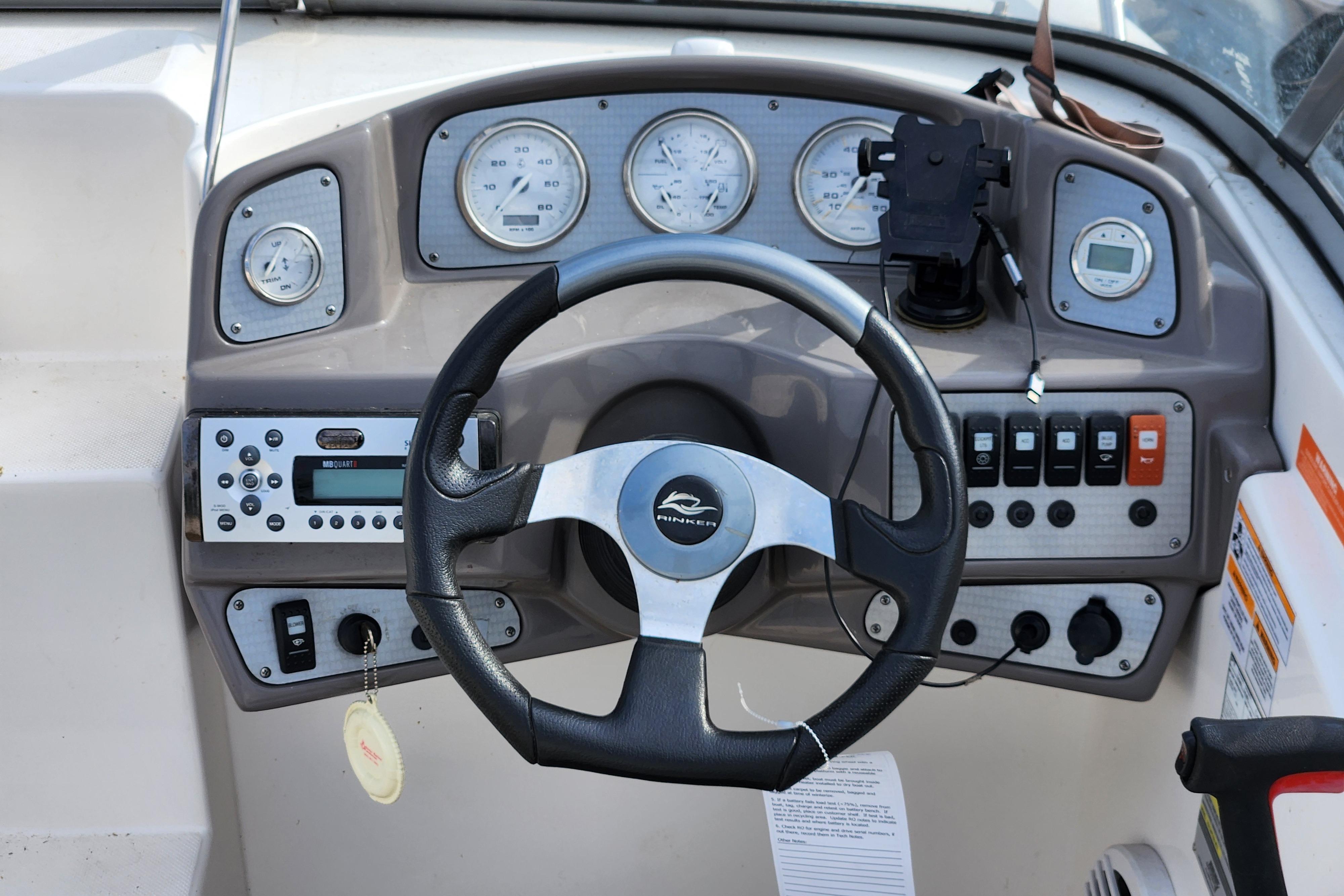 Dashboard of 2009 Rinker 210 Captiva MTX Cuddy boat with steering wheel and gauges.