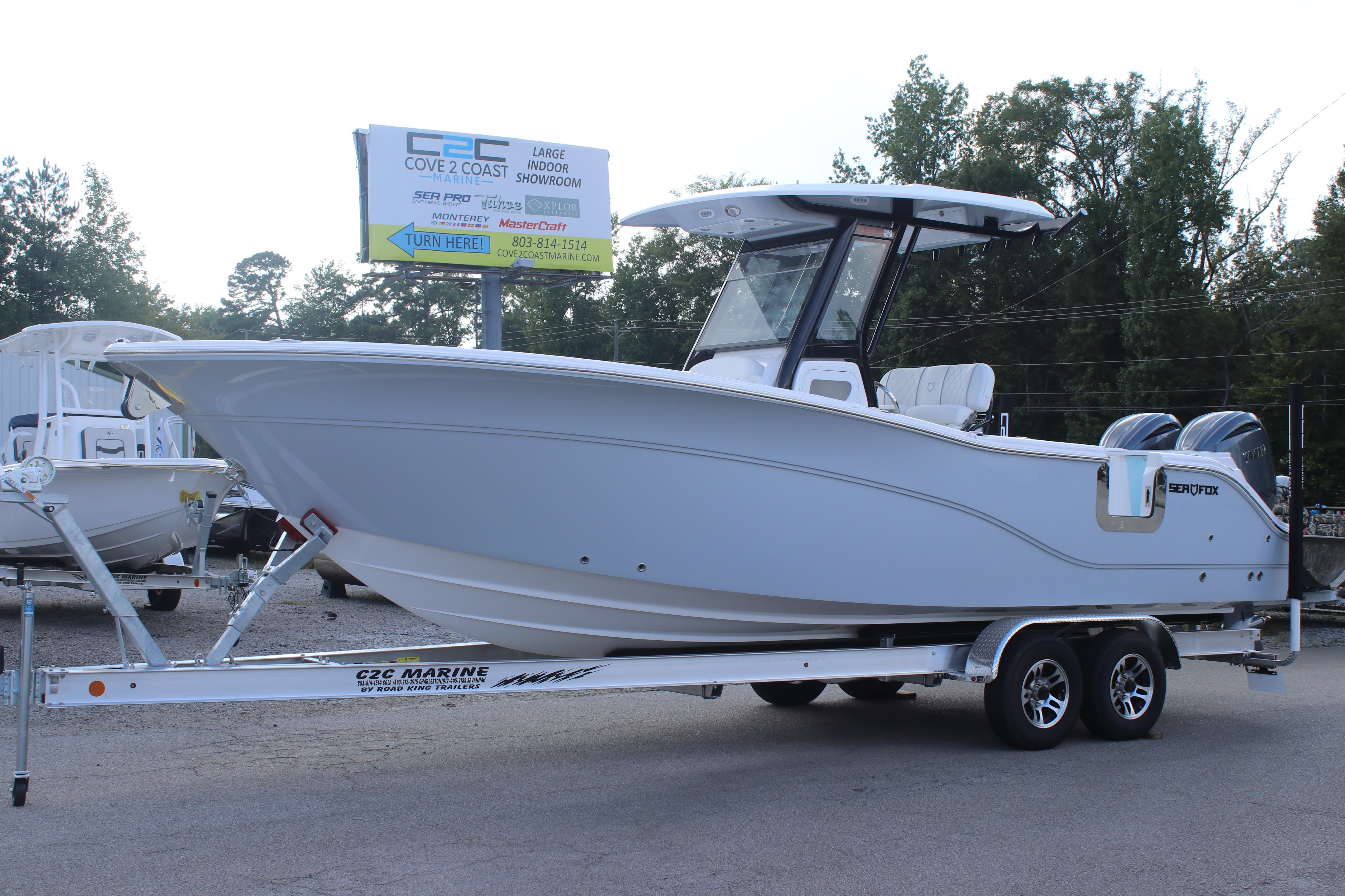 2026 Sea Fox 268 Commander boat on trailer at dealership, side view.