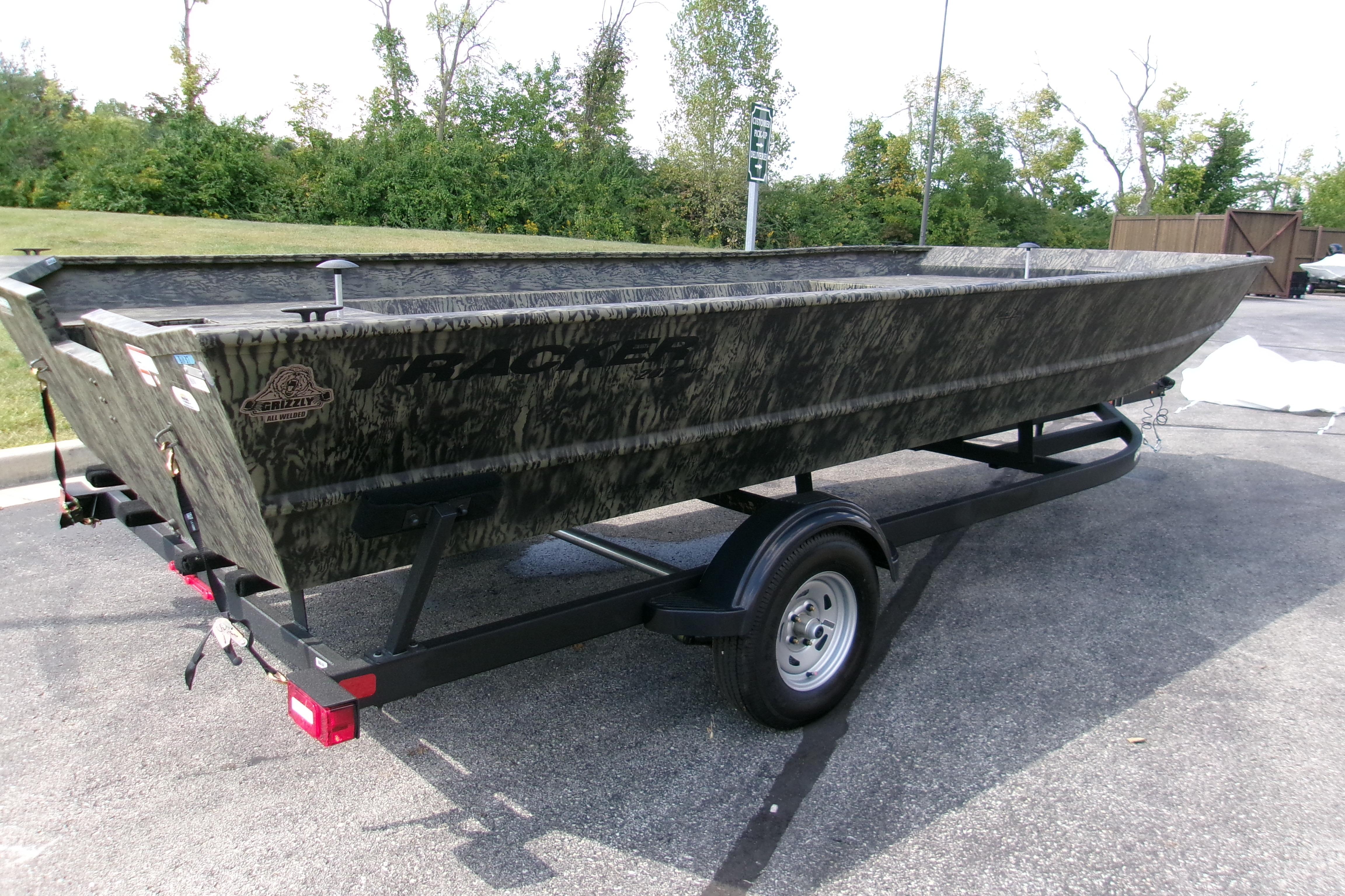 2026 Tracker Grizzly 2072 Utility boat on trailer, parked outdoors.