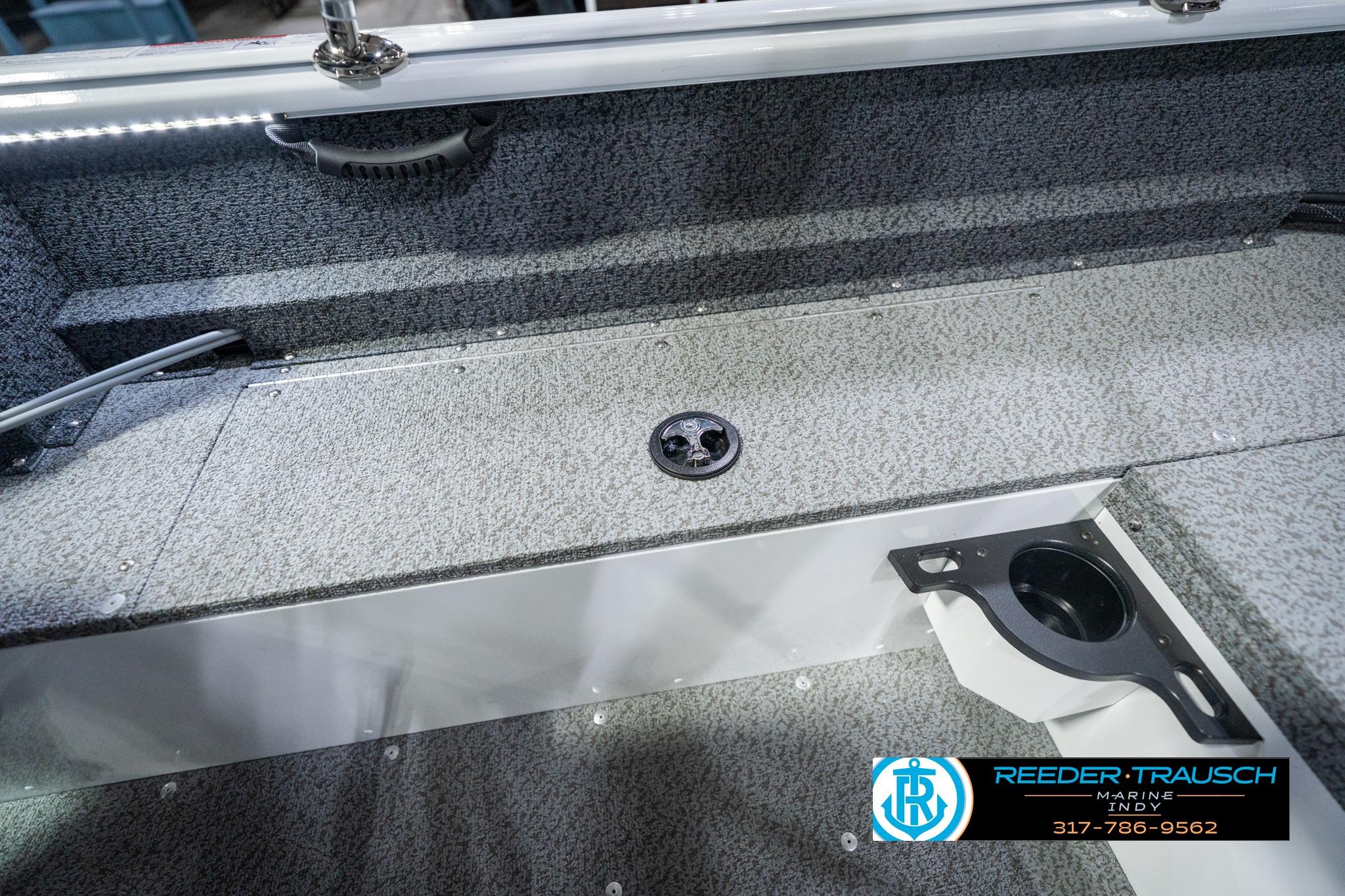 Interior view of 2026 Lund 1700 Explorer Sport boat with carpeted flooring and cup holder.