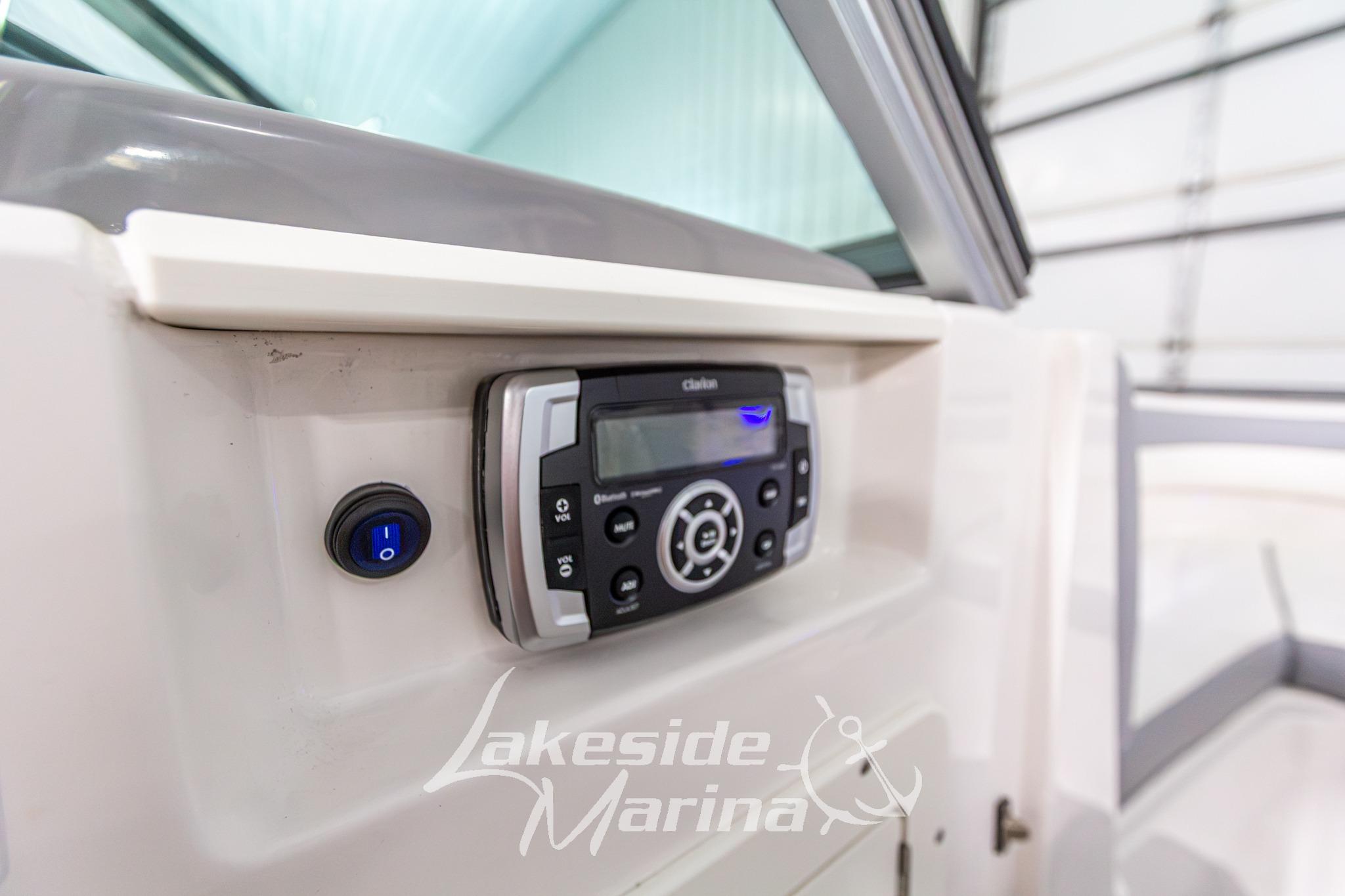 2022 Chaparral 21 SSi boat dashboard with Clarion audio system and power switch.