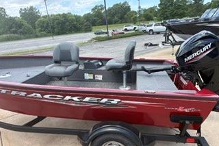 2025 Tracker Super Guide V-16 T boat with Mercury engine, parked on a trailer.