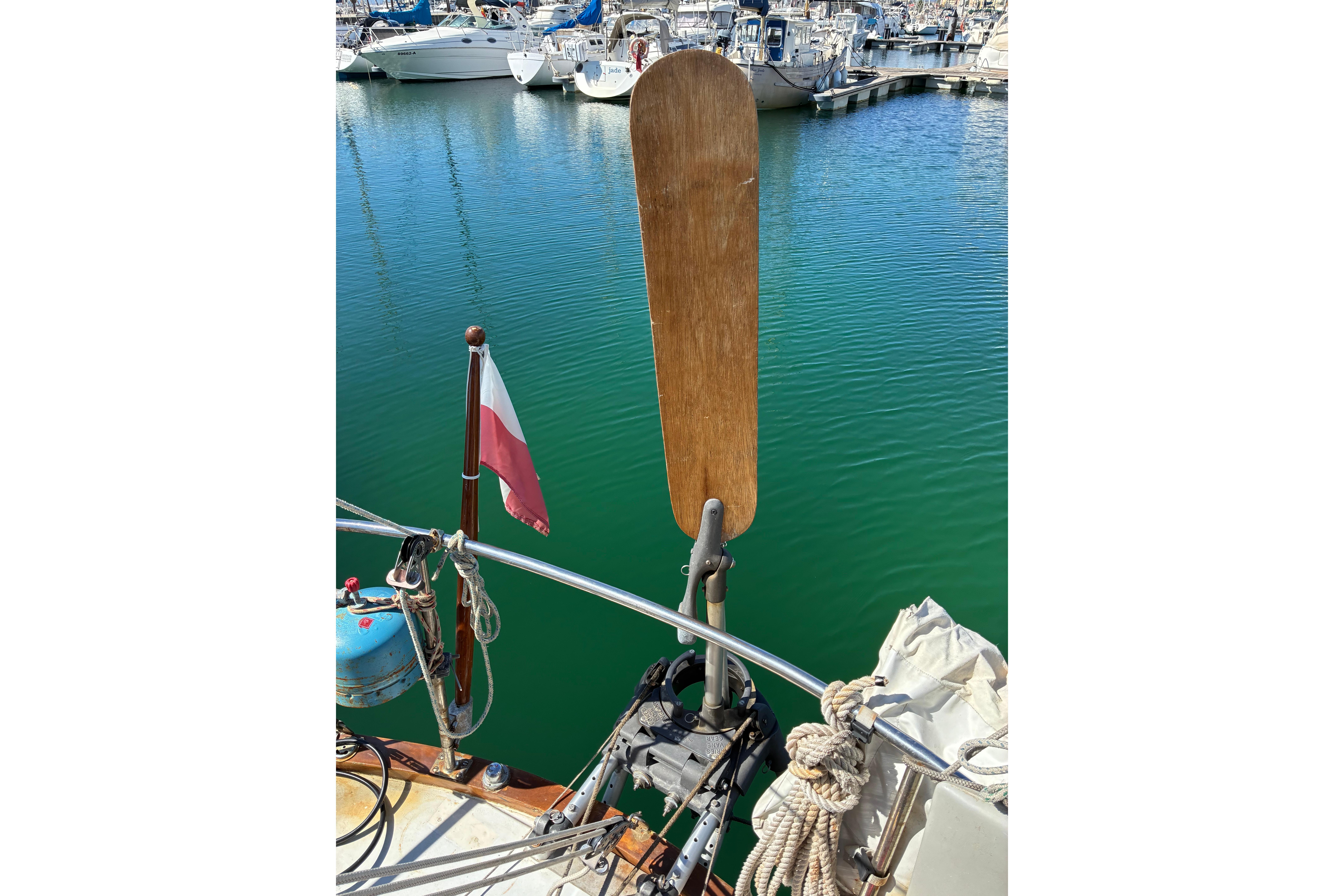 1974 Cheoy Lee Luders Offshore 28 sailboat stern with wind vane in marina.