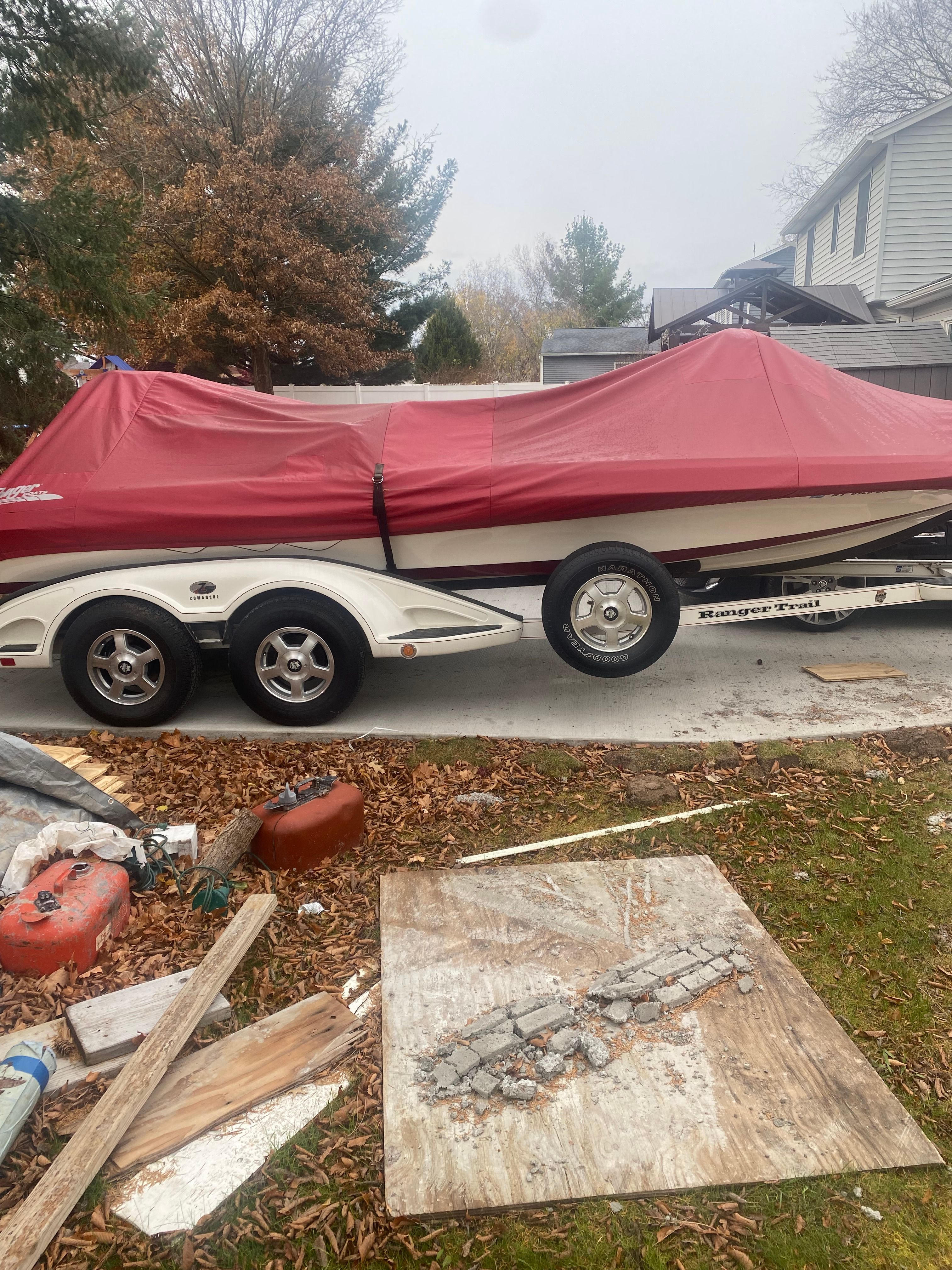 A 2009 Ranger Z520 Comanche boat with a red cover on a trailer.