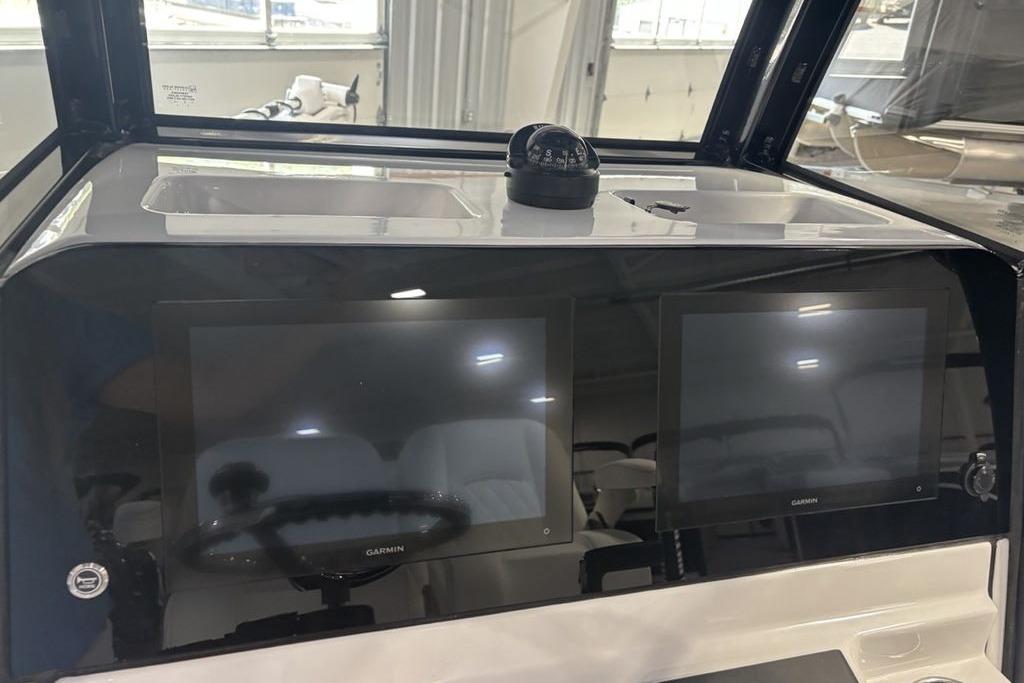 Dashboard of 2026 Sportsman Masters 247 Bay Boat with dual Garmin displays.
