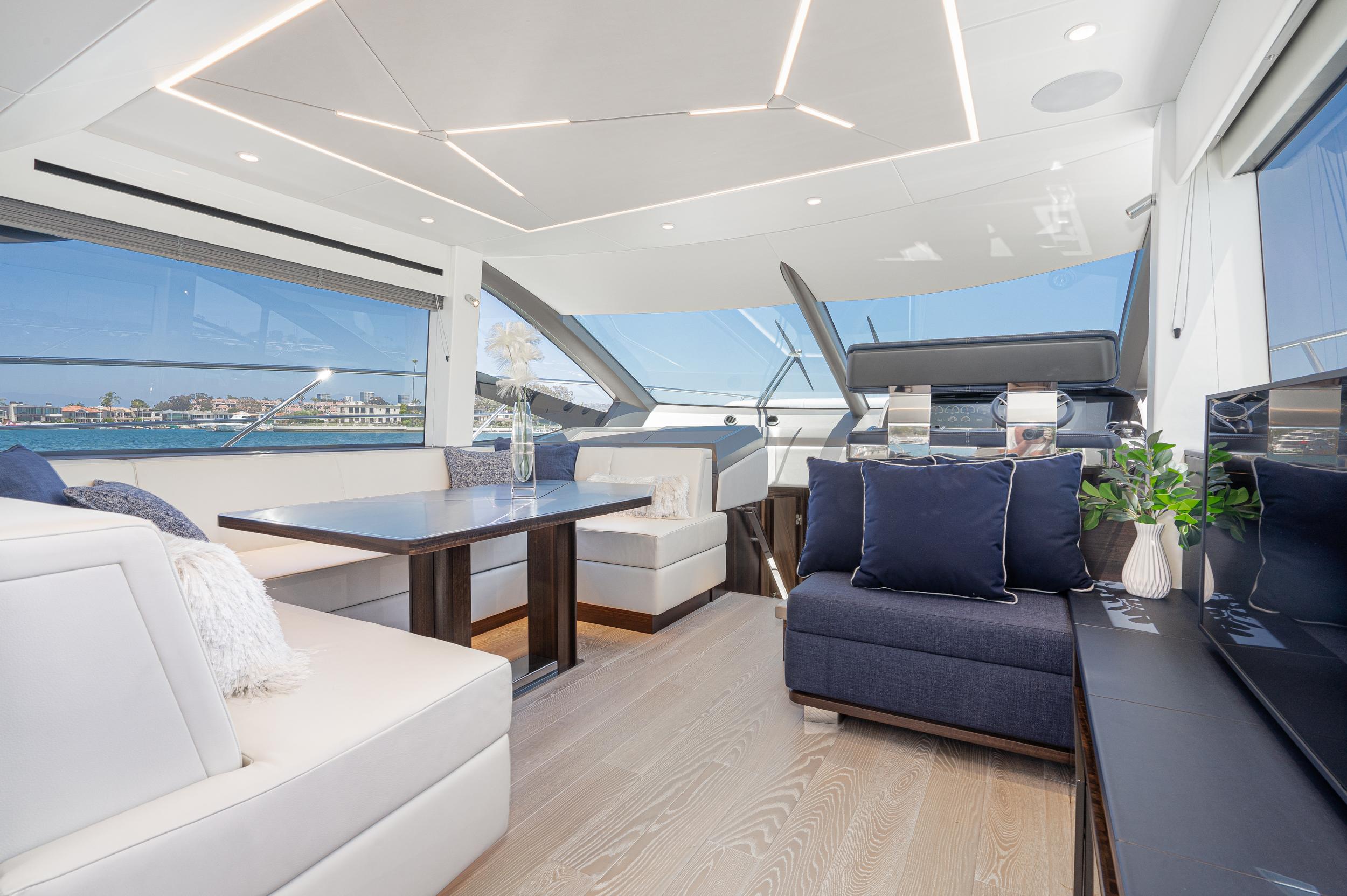 Luxurious interior of 2021 Sunseeker Manhattan 55 yacht with modern seating and panoramic windows.