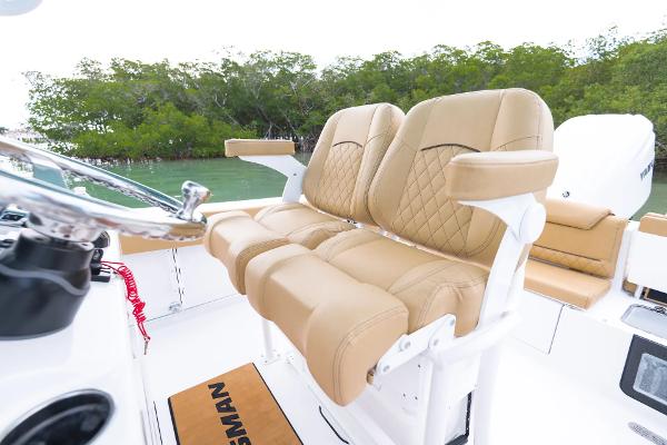 Manufacturer Provided Image: 2025 Sportsman Heritage 231 Center Console with tan seating, lush greenery in background.