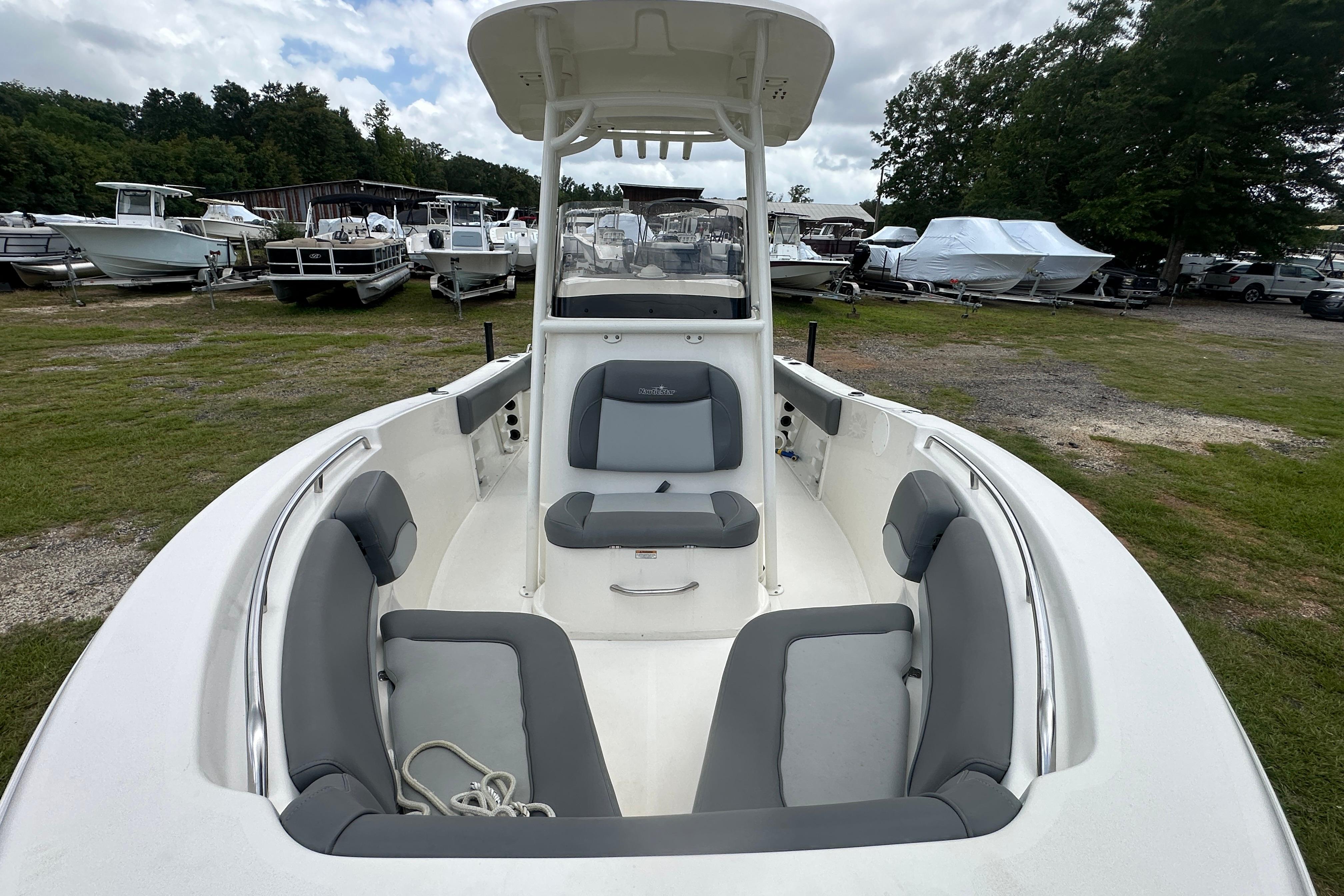 2023 NauticStar 2102 Legacy boat with spacious seating, docked outdoors.