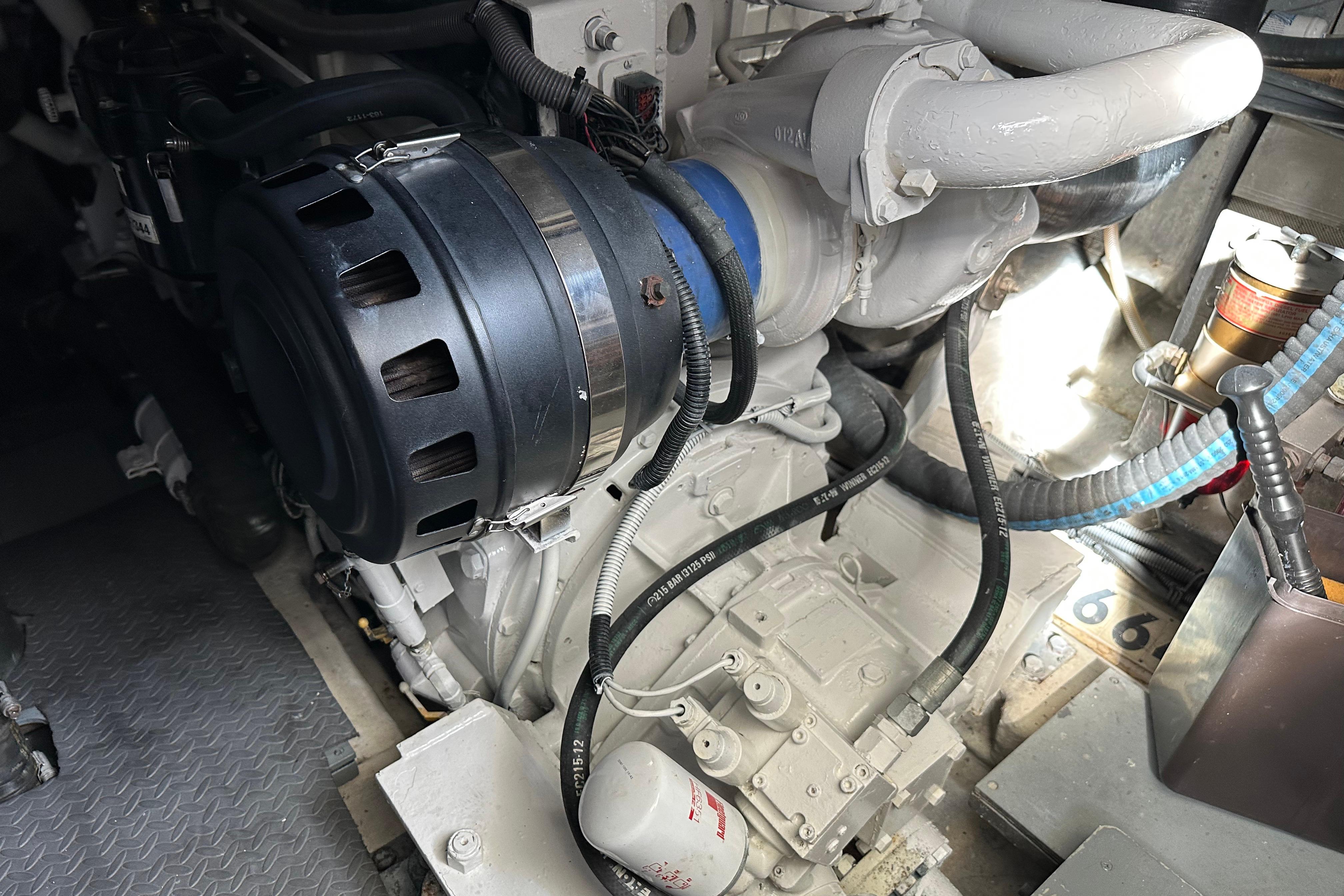 Engine compartment of a 2004 Azimut 55E yacht, showcasing mechanical components and wiring.