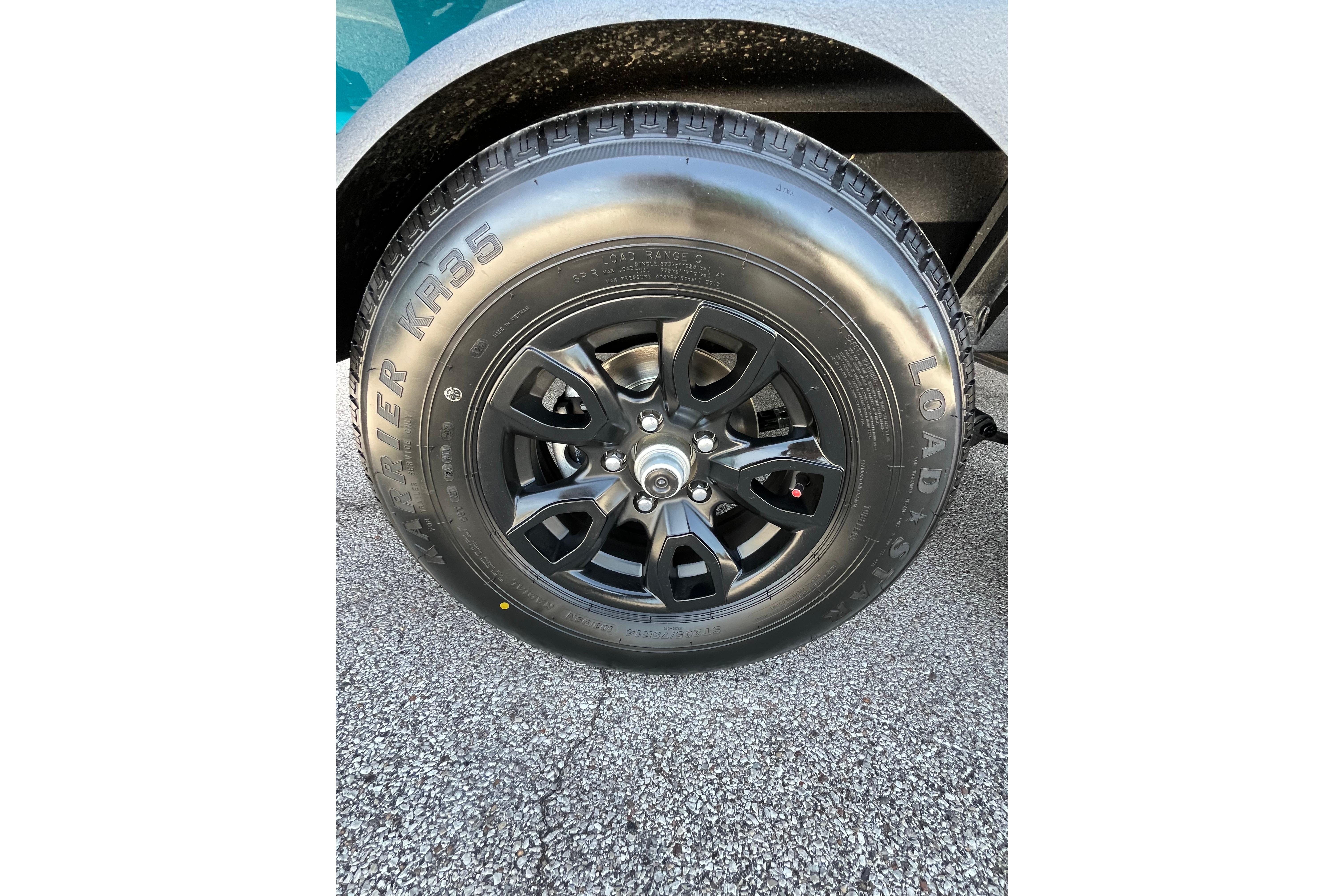 Close-up of a 2026 Tahoe 1950 wheel with black alloy rim and tire.