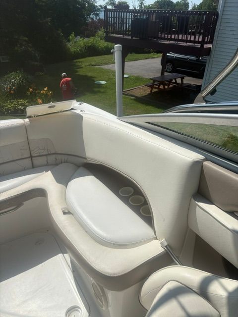 The image shows the white upholstery of a 2003 Cobalt 240 with cup holders.