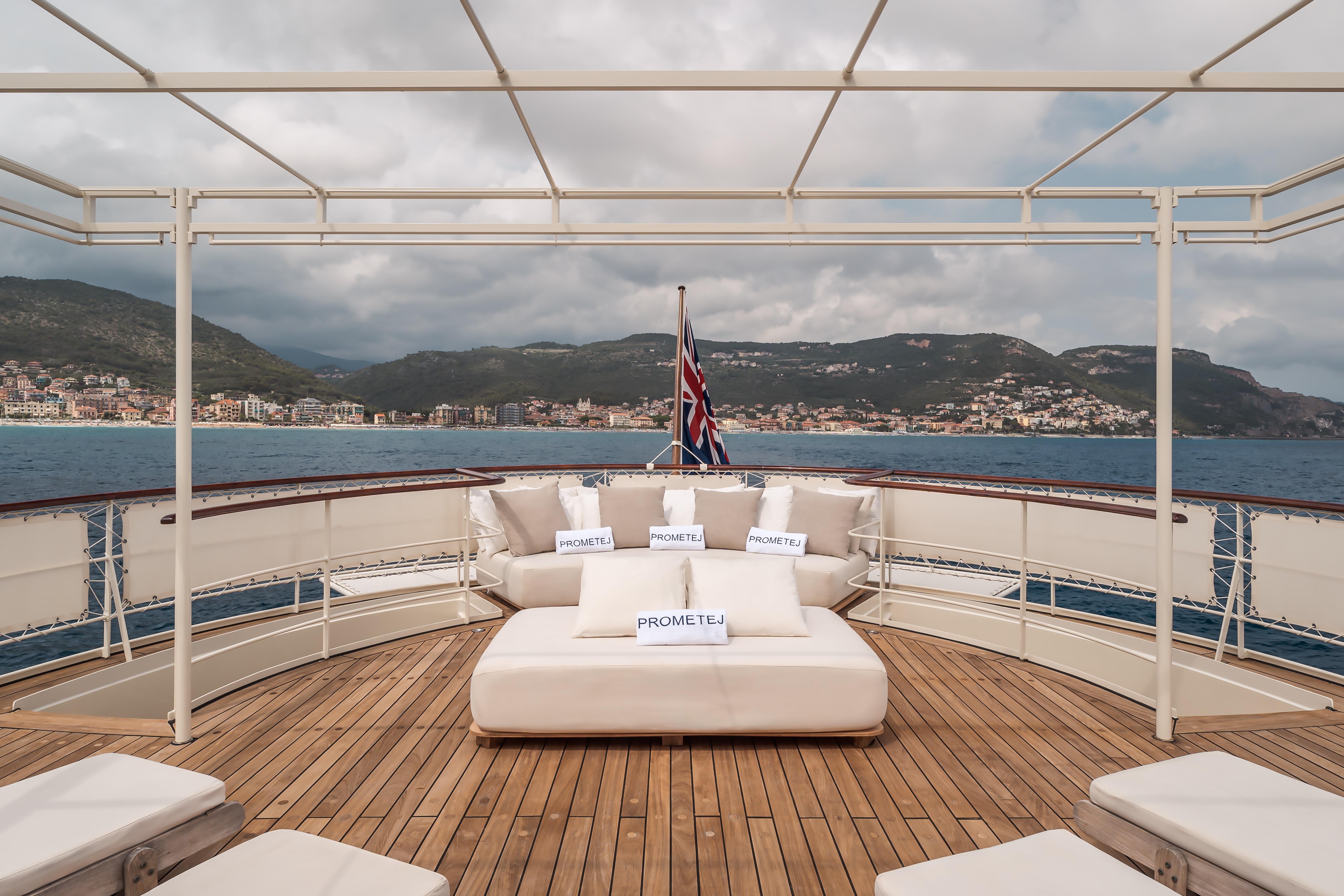 Luxurious deck of 1956 custom converted tug with scenic coastal view.