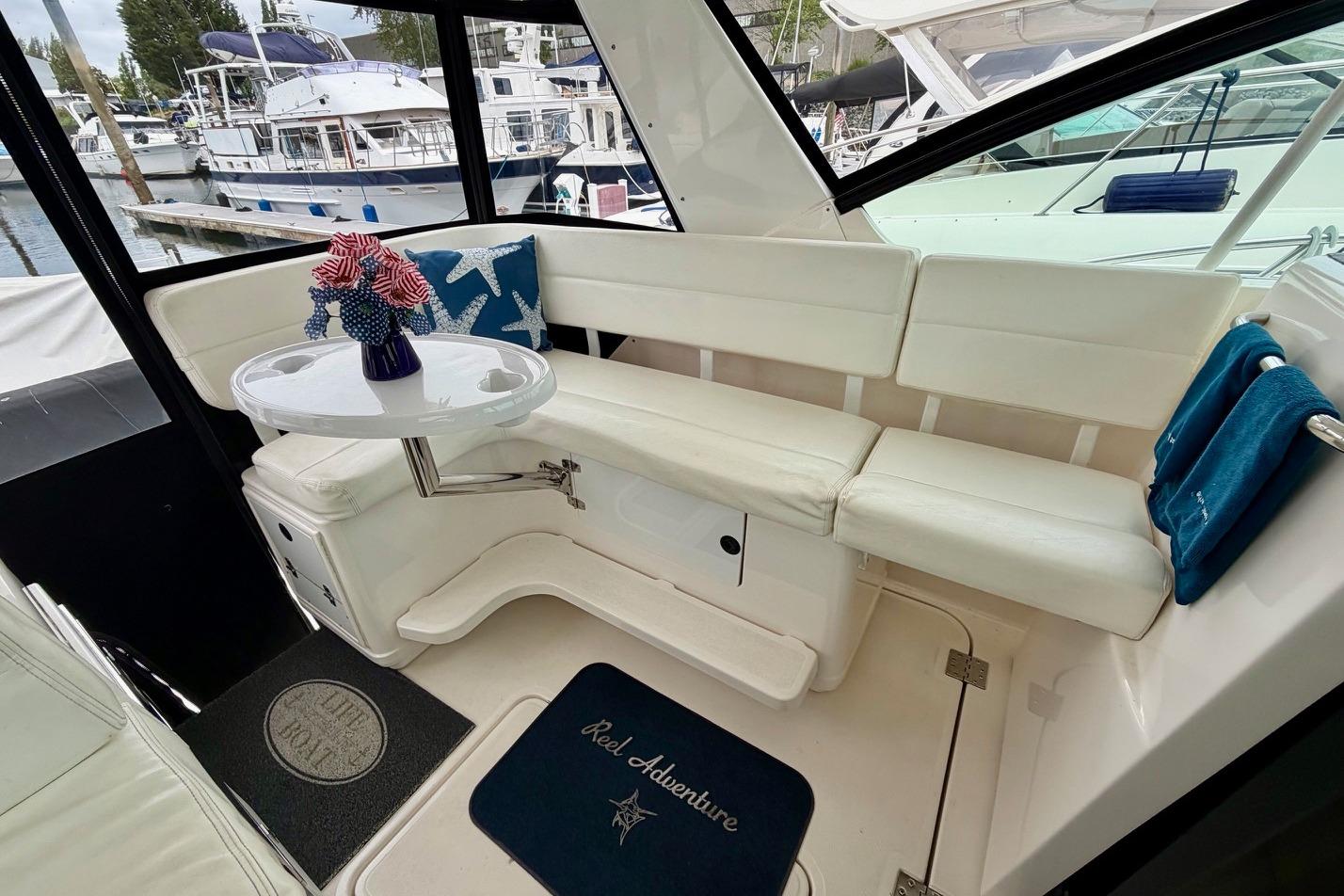 2003 Tiara Yachts 3500 Open interior with white seating and decorative table.